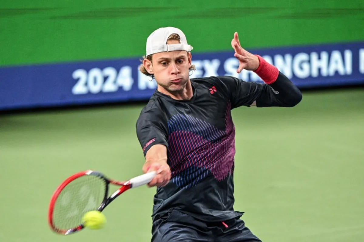 Belgium's Zizou Bergs hits a return to China's Zhizhen Zhang during their men's singles match at the Shanghai Masters tennis tournament in Shanghai on October 3, 2024.  Hector RETAMAL / AFP