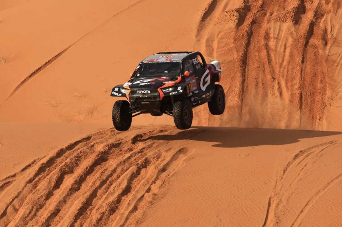 South African driver Henk Lategan and co-driver Brett Cummings compete during Stage 6 of the Dakar Rally 2025, between Hail and Al Duwadimi, Saudi Arabia, on January 11, 2025.  Valery HACHE / AFP