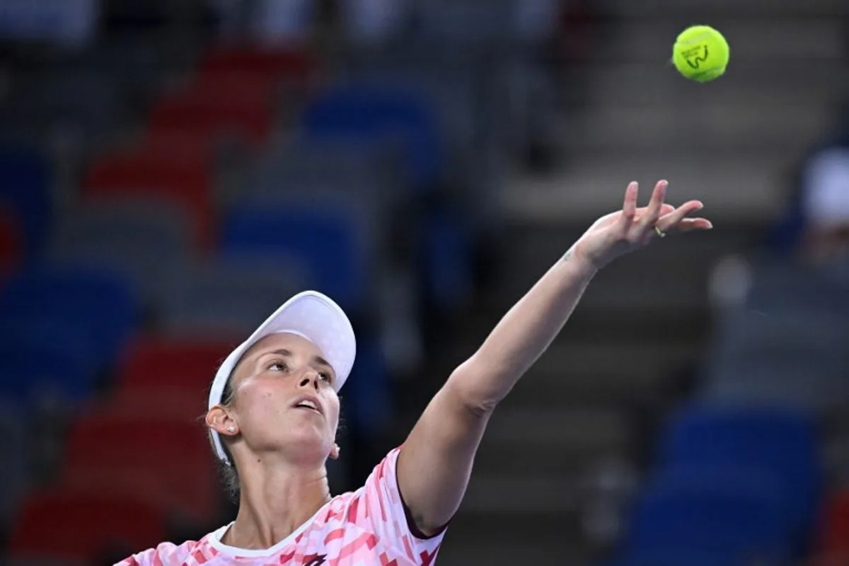 Belgium's Elise Mertens serves to Croatia's Donna Vekic during their women's singles match at the Wuhan Open tennis tournament in Wuhan, China's Hubei province on October 7, 2024.  WANG Zhao / AFP