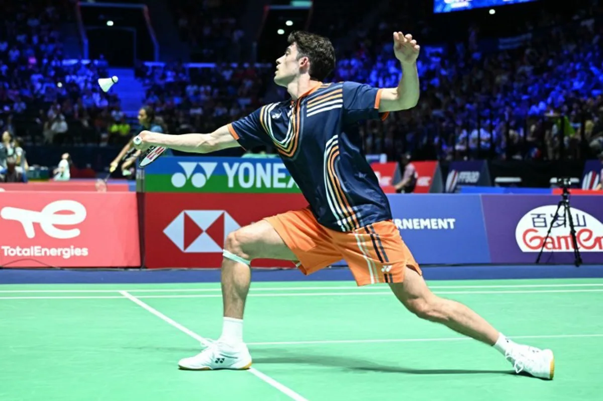Belgium's Julien Carraggi hits a return to China's Yu Qi Shi during their men's single match at the Badminton BWF World Championships at the Adidas Arena in Paris, on August 27, 2025. Bertrand GUAY / AFP