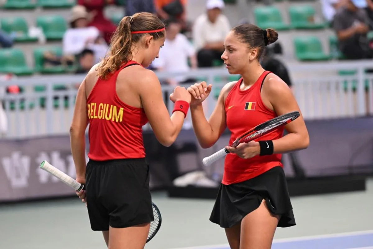 Belgium's Hanne Vandewinkel (L) and Sofia Costoulas (R) speak during their women's doubles match against China's Guo Hanyu and Jiang Xinyu at the Billie Jean King Cup tennis play-offs at the Guangzhou Nansha International Tennis Center in Guangzhou, in south China's Guangdong province on November 17, 2024. STR / AFP