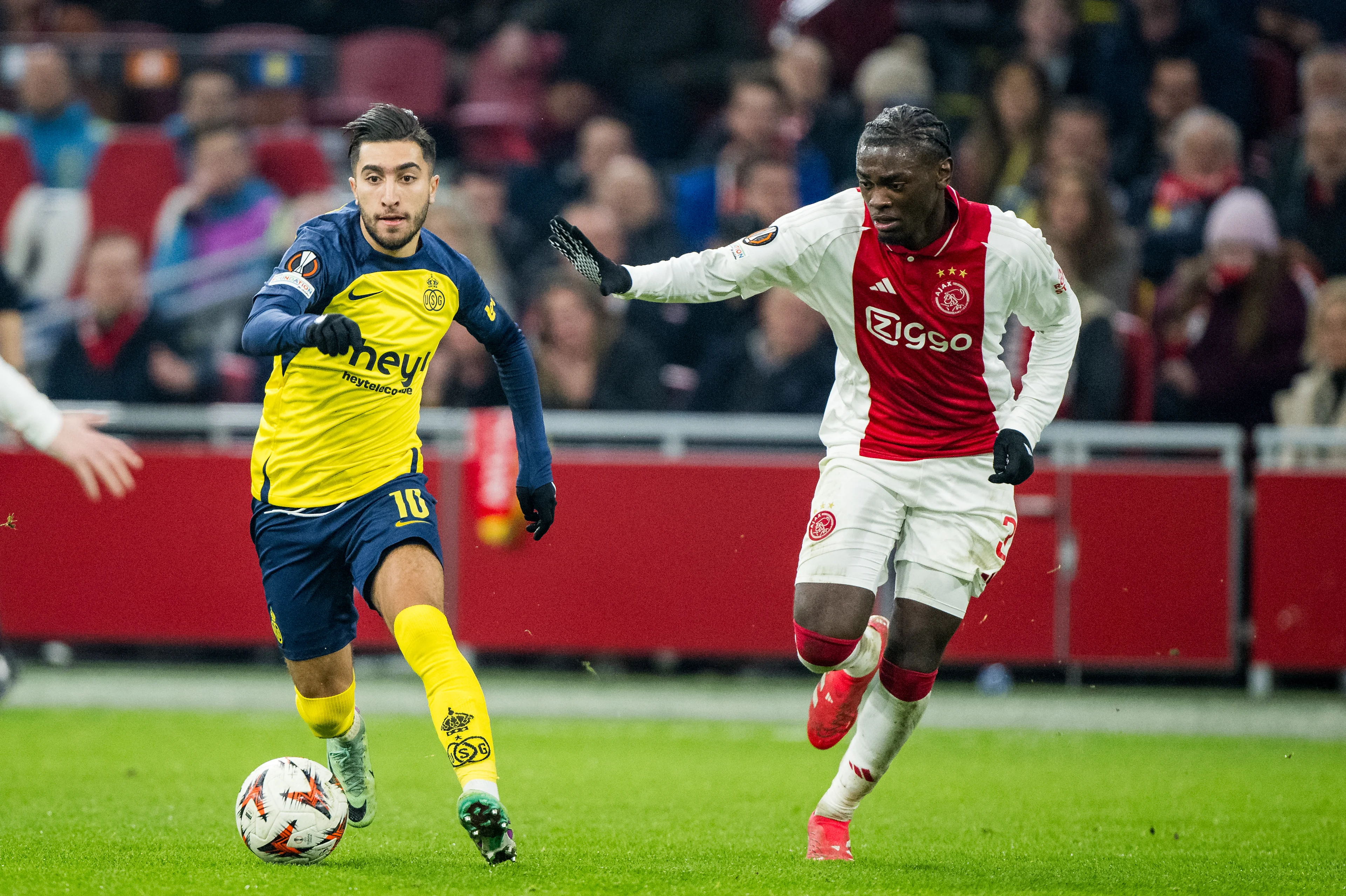 Union's Anouar Ait El Hadj and Ajax' Jorthy Mokio fight for the ball during a soccer match between Dutch AFC Ajax and Belgian Royale Union Saint-Gilloise, Thursday 20 February 2025 in Amsterdam, the Netherlands, the return leg of the Knockout phase play-offs of the UEFA Europa League competition. BELGA PHOTO JASPER JACOBS