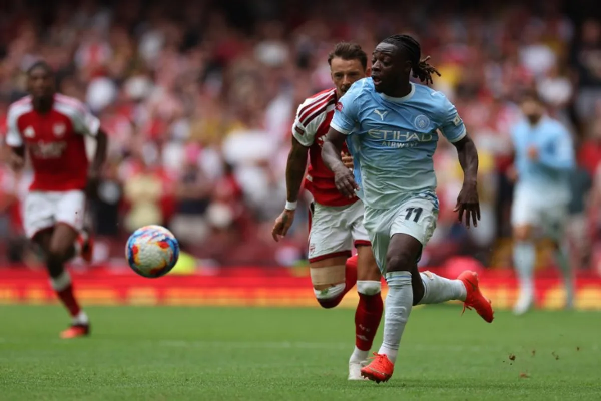 Manchester City's Belgian midfielder #11 Jeremy Doku runs with the ball during the English FA Community Shield football match between Arsenal and Manchester City at The Principality Stadium, in Cardiff, south Wales on August 16, 2026. Adrian Dennis / AFP