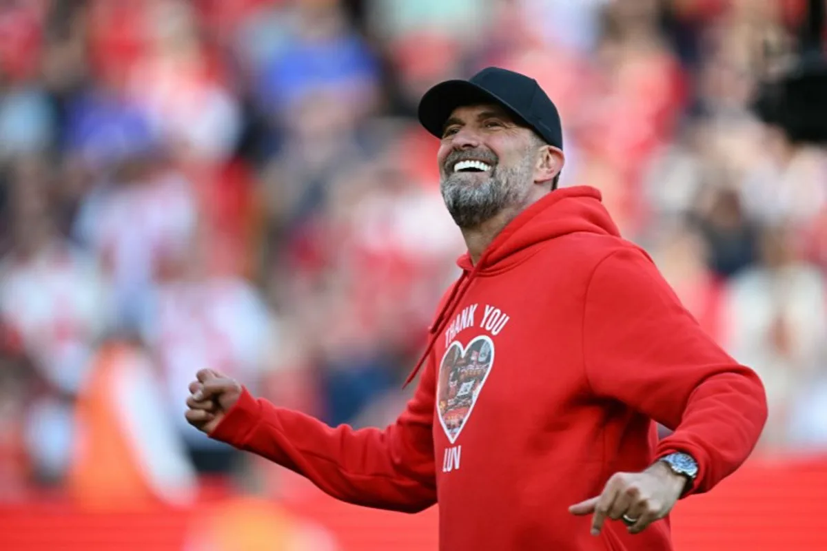 Liverpool's German manager Jurgen Klopp smiles as he makes his final farewell to fans after the English Premier League football match between Liverpool and Wolverhampton Wanderers at Anfield in Liverpool, north west England on May 19, 2024. Jurgen Klopp was given a heartfelt reception by home fans at Anfield as he walked out for his final match as Liverpool manager on Sunday. Klopp, who arrived at the club in October 2015, won seven major trophies at Liverpool, including the club's first league title for 30 years and the 2019 Champions League. Paul ELLIS / AFP