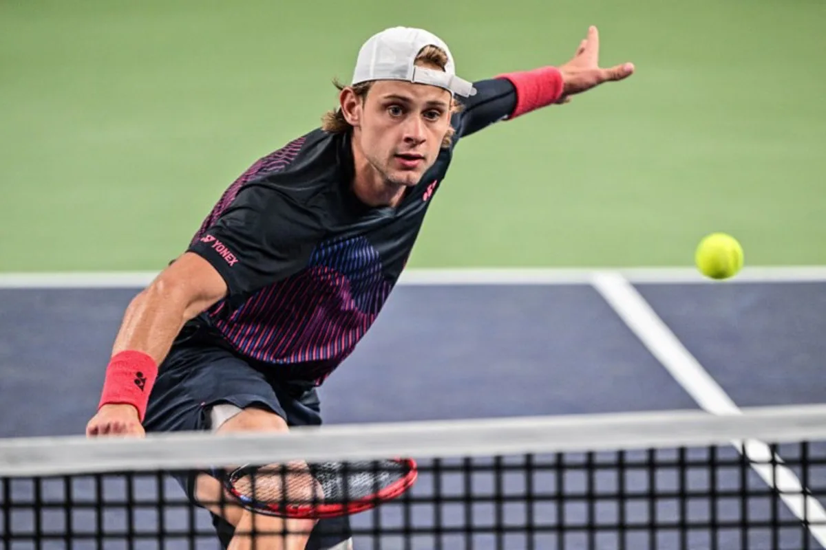 Belgium's Zizou Bergs hits a return to China's Zhizhen Zhang during their men's singles match at the Shanghai Masters tennis tournament in Shanghai on October 3, 2024.  Hector RETAMAL / AFP