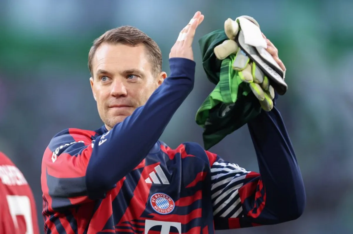(FILES) Bayern Munich's German goalkeeper #01 Manuel Neuer acknowledges the fans after the German first division Bundesliga football match between VfL Wolfsburg and FC Bayern Munich in Wolfsburg, on May 9, 2026. Bayern Munich veteran Manuel Neuer announced on May 15, 2026 that he has extended his contract at the German champions by one year until 2027. The 40-year-old goalkeeper's deal was set to expire in the summer but he will stay on in Munich for what will be a 16th year at the Bavarian giants. Ronny HARTMANN / AFP