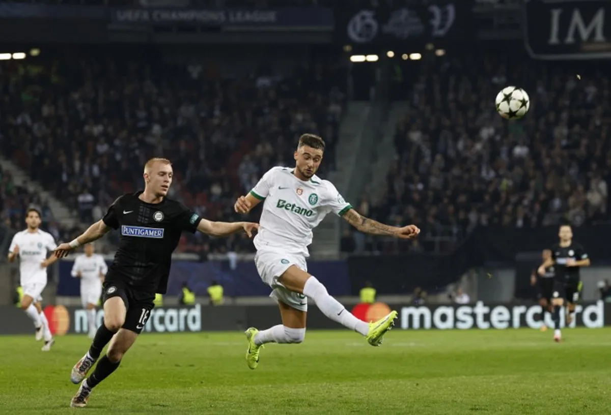 Sturm Graz's Danish forward #18 Mika Biereth (L) and Sporting Lisbon's Belgian defender #06 Zeno Debast vie for the ball during the UEFA Champions League football match between SK Sturm Graz and Sporting CP in Klagenfurt, Austria on October 22, 2024.   ERWIN SCHERIAU / APA / AFP