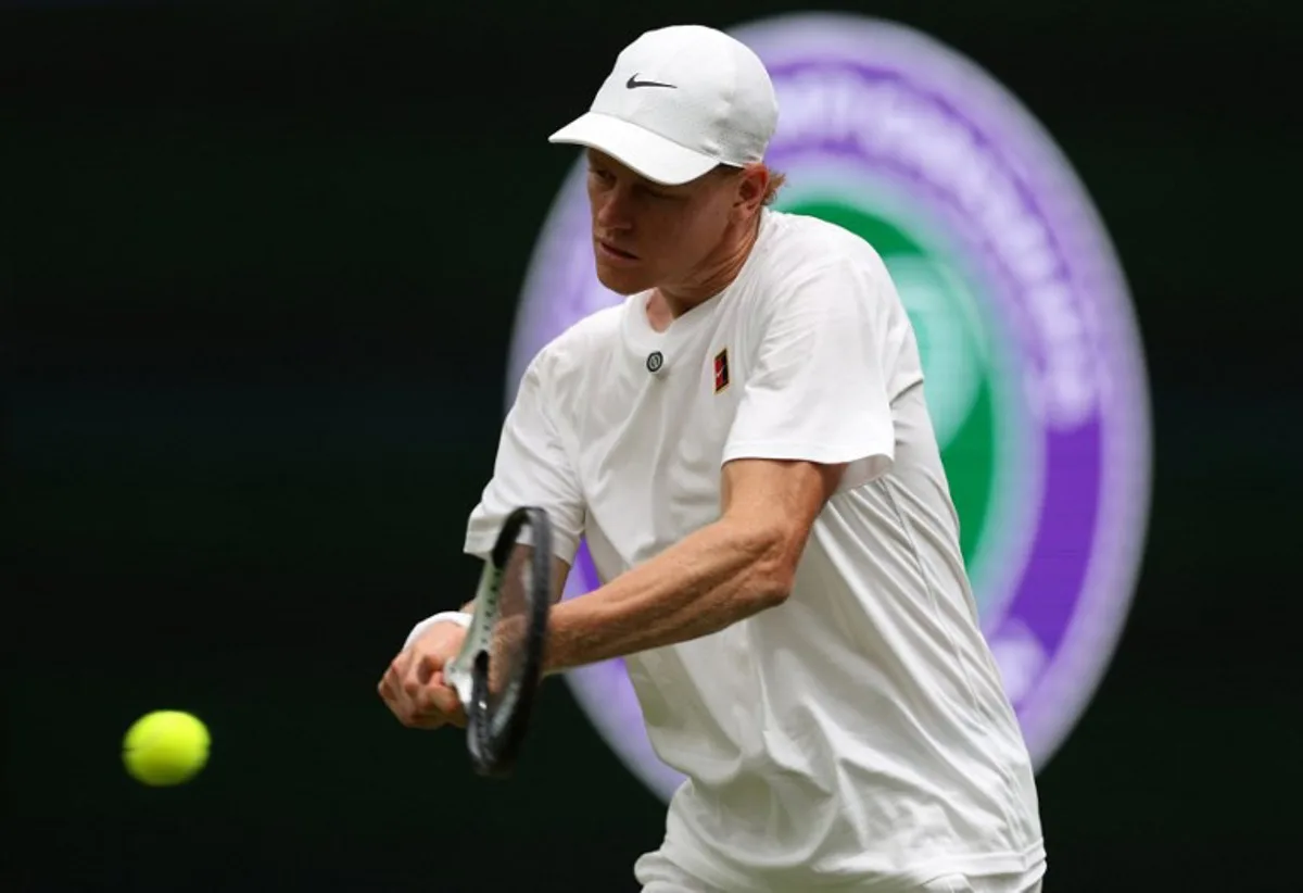 Italy's Jannik Sinner practices with Serbia's Novak Djokovic on No. 1 Court at The All England Lawn Tennis and Croquet Club in Wimbledon, southwest London, on June 25, 2026, ahead of the 2026 Wimbledon Championships.  Adrian Dennis / AFP