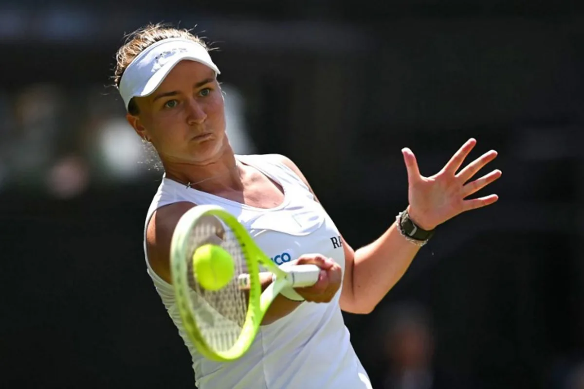 Czech Republic's Barbora Krejcikova plays a forehand return to Philippines' Alexandra Eala during their women's singles first round tennis match on the second day of the 2025 Wimbledon Championships at The All England Lawn Tennis and Croquet Club in Wimbledon, southwest London, on July 1, 2025. Glyn KIRK / AFP