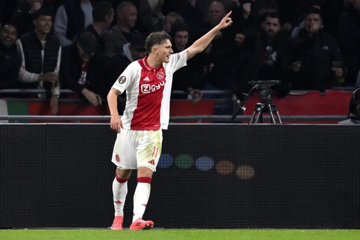 Ajax's Belgian forward #11 Mika Godts celebrates scoring his team' second goal during the UEFA Europa League football match between Ajax Amsterdam and Besiktas at The Johan Cruijff Arena Stadium in Amsterdam on September 26, 2024.  JOHN THYS / AFP