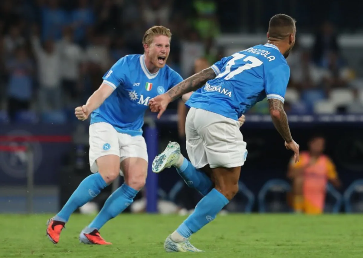 Napoli's Italian defender #37 Leonardo Spinazzola (R) celebrates after scoring his team's second goal during the Italian Serie A football match between SSC Napoli and Pisa SC at the Diego Armando Maradona Stadium in Naples on September 22, 2025. CARLO HERMANN / AFP