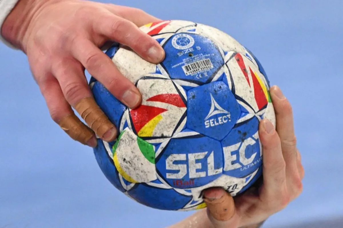 Sweden's pivot #05 Max Darj (L) and Netherlands' centre back #22 Luc Steins vie for the ball during the men's EURO 2024 EHF Handball European Championship match Group E Sweden v The Netherlands in Mannheim, western Germany on January 15, 2024.  Kirill KUDRYAVTSEV / AFP