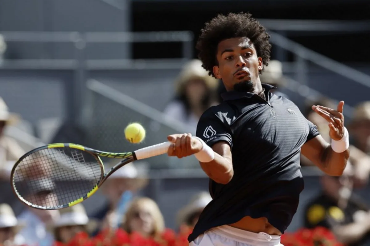 France's Arthur Fils returns the ball to Italy's Jannik Sinner during their 2026 ATP Tour Madrid Open tennis tournament semi-final singles match at the Caja Magica in Madrid, on May 1, 2026. Oscar DEL POZO / AFP