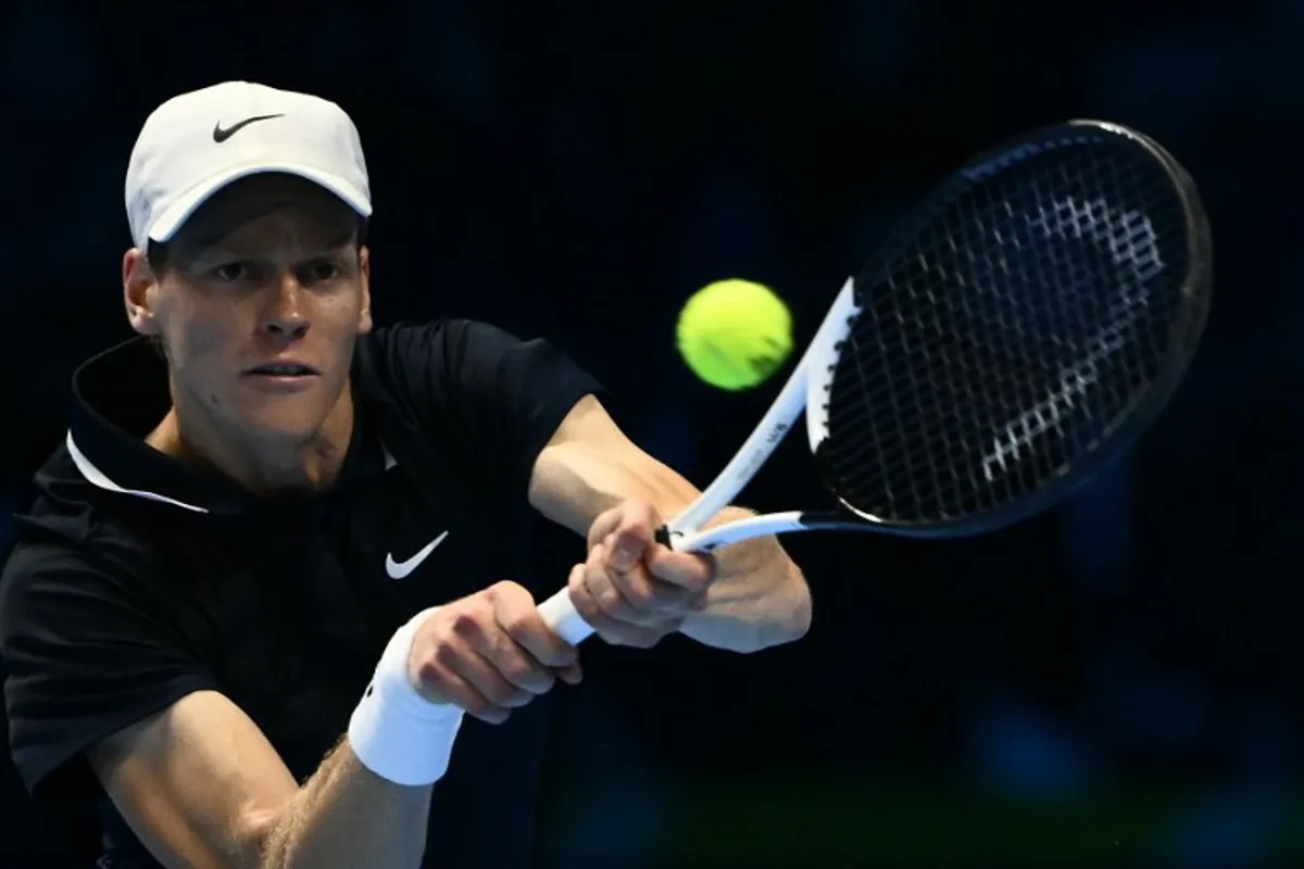 Italy's Jannik Sinner hits a return to USA's Taylor Fritz during their match at the ATP Finals tennis tournament in Turin on November 12, 2024.  Marco BERTORELLO / AFP