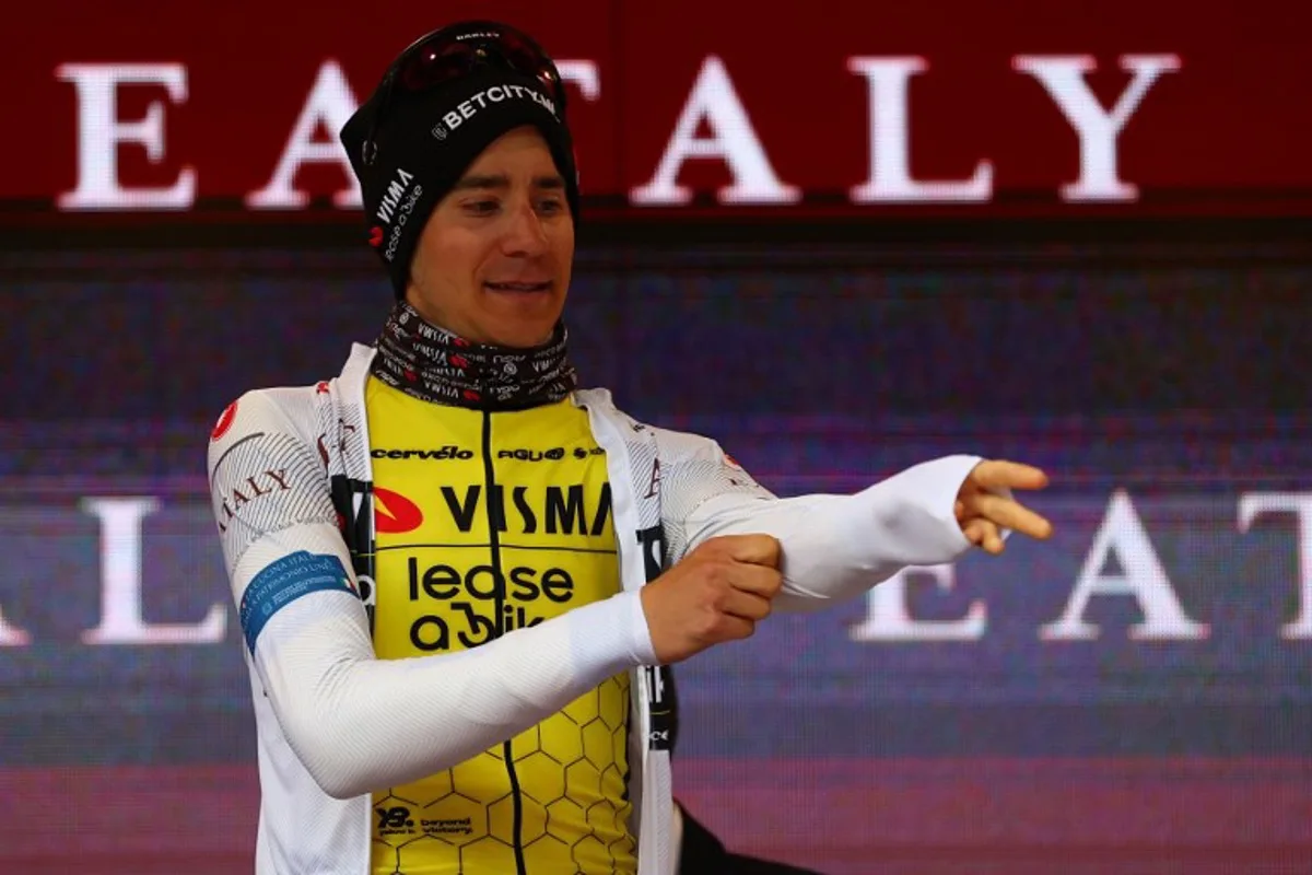 Team Visma-Lease a Bike's Belgian rider Cian Uijtdebroeks celebrates the best young rider's white jersey on the podium of the 10th stage of the 107th Giro d'Italia cycling race, 142km between Pompei and Cusano Mutri (Bocca della Selva), on May 14, 2024.   Luca Bettini / AFP