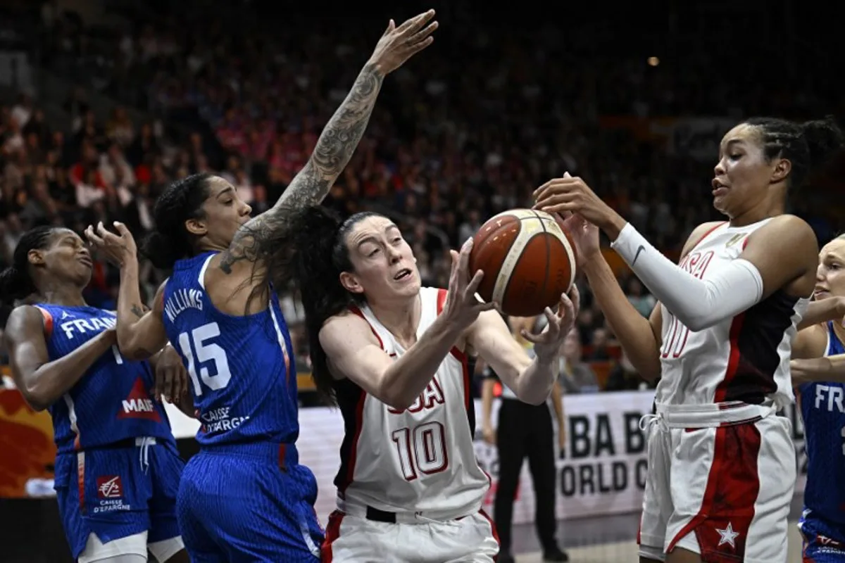France's forward #15 Gabby Williams and USA's power forward #10 Breanna Stewart vie for the ball during the 2026 FIBA Women's Basketball World Cup final game between the United States and France in Berlin on September 13, 2026.  Tobias SCHWARZ / AFP