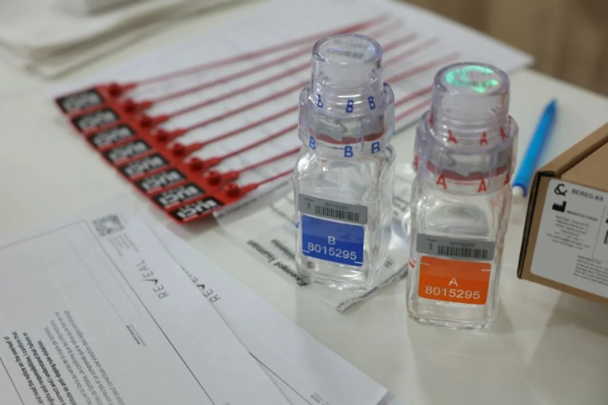 This photograph taken on July 5, 2024, shows anti-doping testing kit materials displayed at the International Testing Agency (ITA) testing facility inside a truck at the finish line of the 7th stage of the 111th edition of the Tour de France cycling race, 25,3 km individual time trial between Nuits-Saint-Georges and Gevrey-Chambertin. The overall leader yellow jersey rider and stage winner are systematically summoned to be tested for doping after the day's stage, along with any rider selected by ITA based on performance or intelligence from the organisation's investigative department. A chaperon escorts the rider to the facility where a supervised urine sample is collected for testing. Thomas SAMSON / AFP