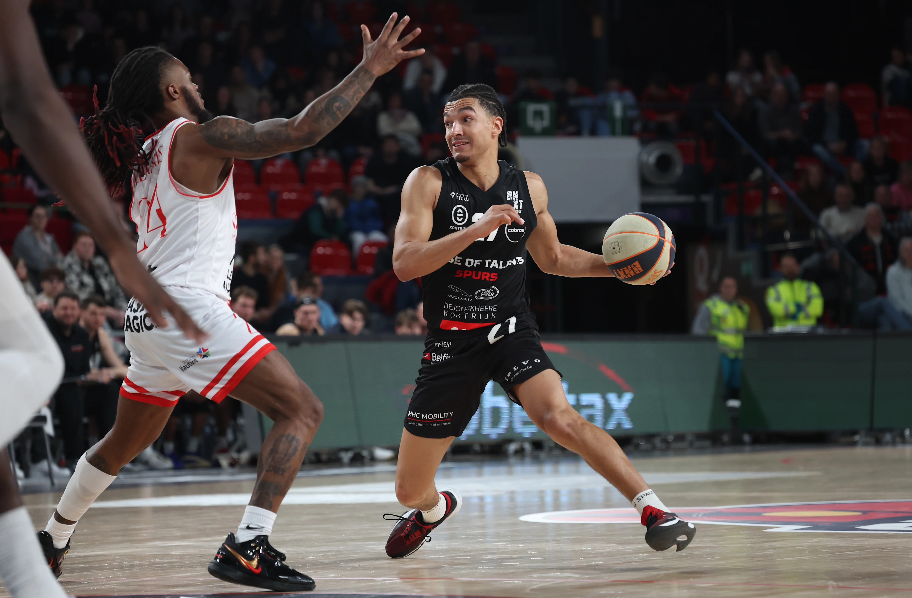 Spirou's Cobe Williams and Kortrijk's Sean Pouedet fight for the ball during a basketball match between Spirou Charleroi and House of Talents Spurs Kortrijk, Friday 29 November 2024 in Charleroi, on day 12 of the 'BNXT League' Belgian/ Dutch first division basket championship. BELGA PHOTO VIRGINIE LEFOUR