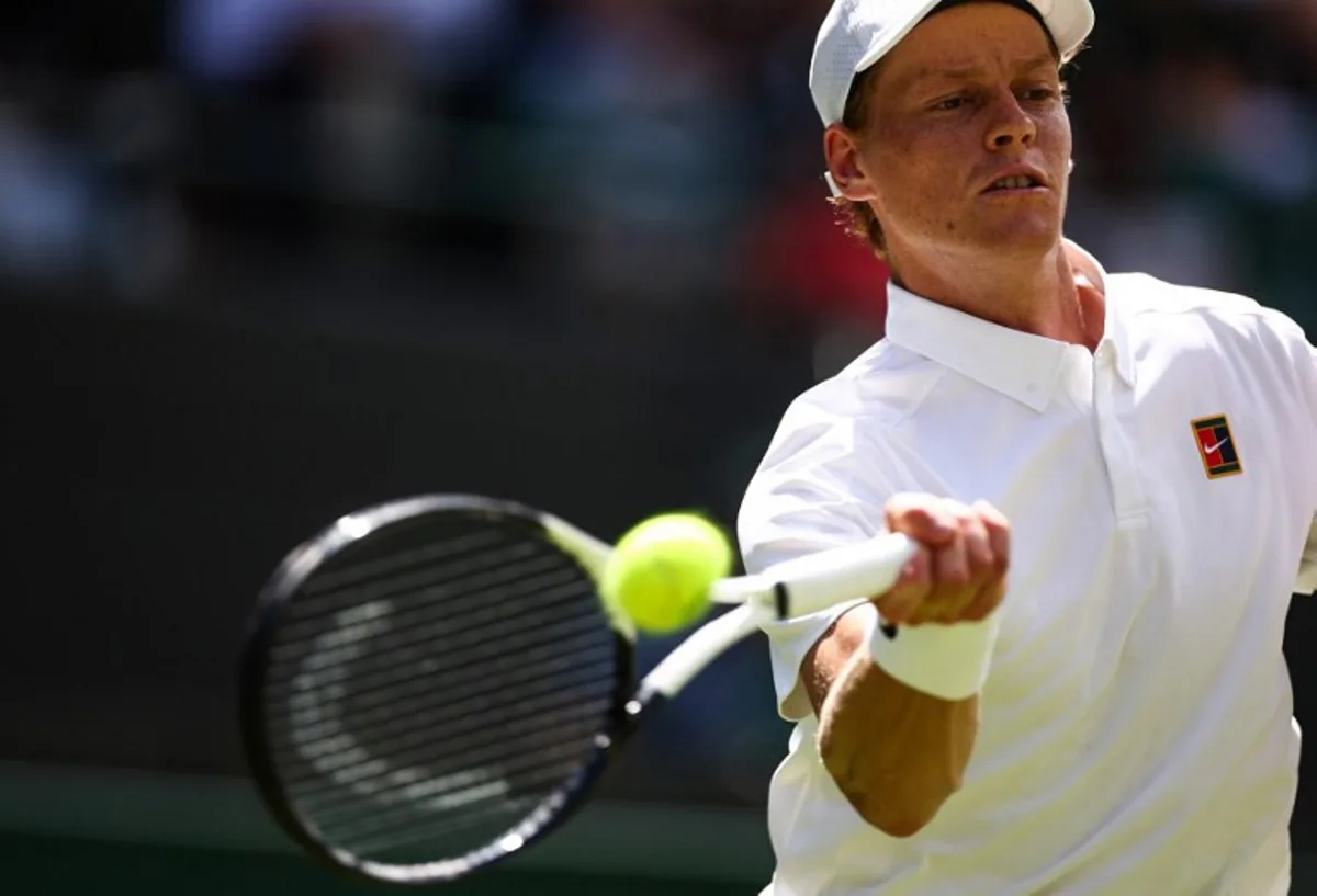Italy's Jannik Sinner plays a forehand return to Italy's Luca Nardi during their men's singles first round tennis match on the second day of the 2025 Wimbledon Championships at The All England Lawn Tennis and Croquet Club in Wimbledon, southwest London, on July 1, 2025. HENRY NICHOLLS / AFP