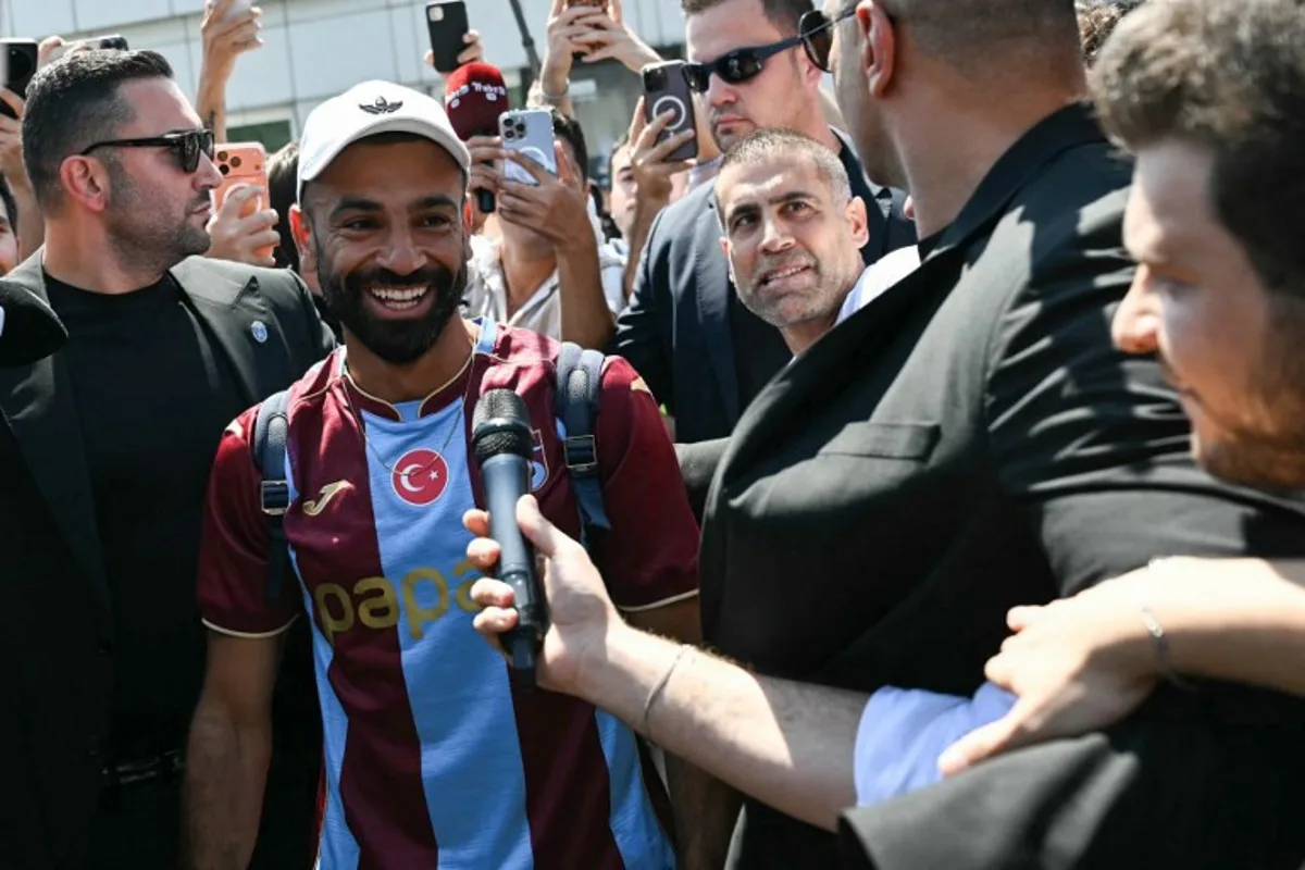 Egyptian forward Mohamed Salah reacts as he arrives at Istanbul Ataturk Airport to complete his transfer to Turkish football club Trabzonspor in Istanbul on August 5, 2026. Ozan KOSE / AFP