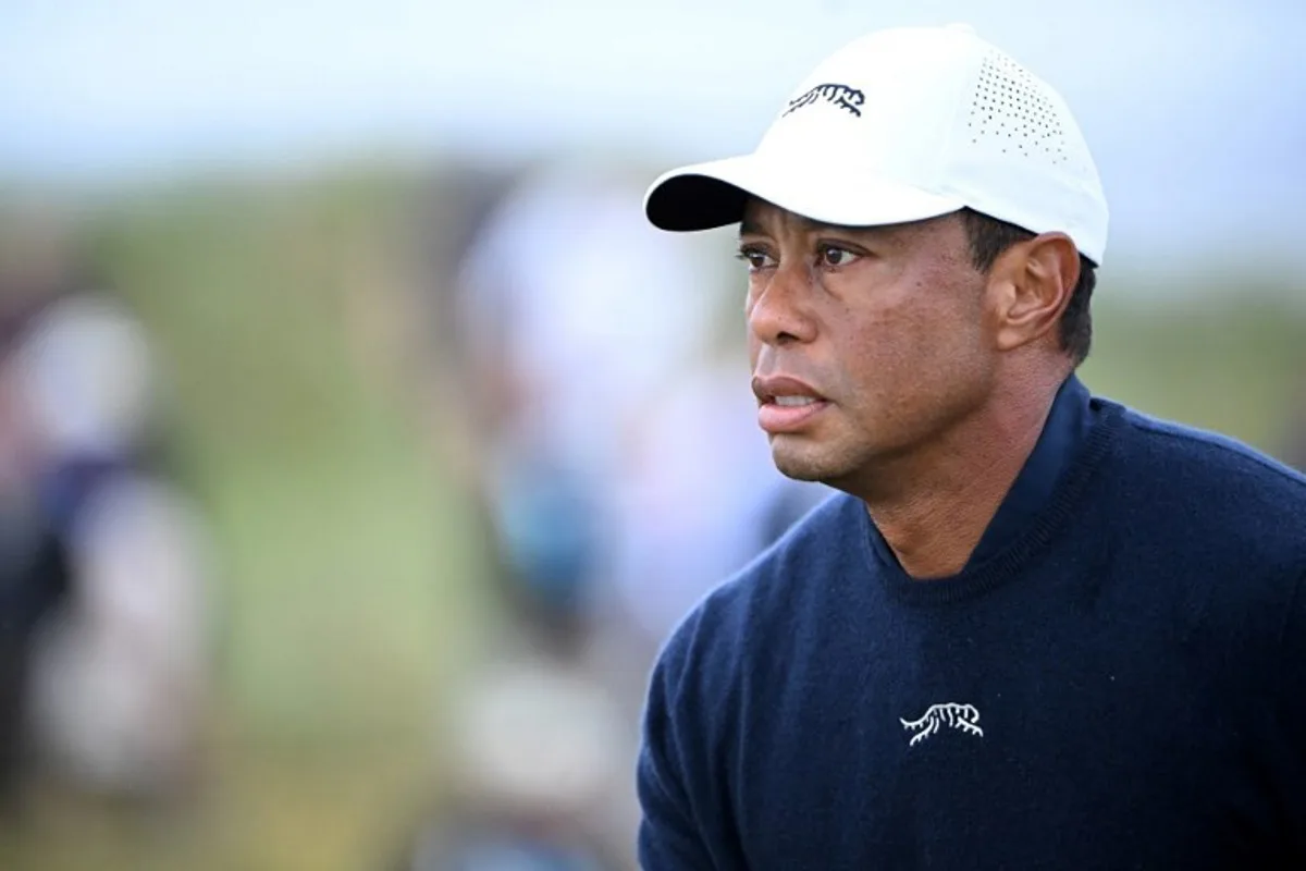 (FILES) US golfer Tiger Woods reacts after driving from the 4th tee during his second round, on day two of the 152nd British Open Golf Championship at Royal Troon on the south west coast of Scotland on July 19, 2024. Woods said on February 10, 2025 he was "just not ready" as he announced he will not play in this week's Genesis Invitational at Torrey Pines as planned following his mother's death. Woods had committed to his first professional tournament in seven months in the Genesis, a US PGA Tour event he hosts. His decision to play came just days after Woods announced his mother, Kultida, had died last week.  ANDY BUCHANAN / AFP