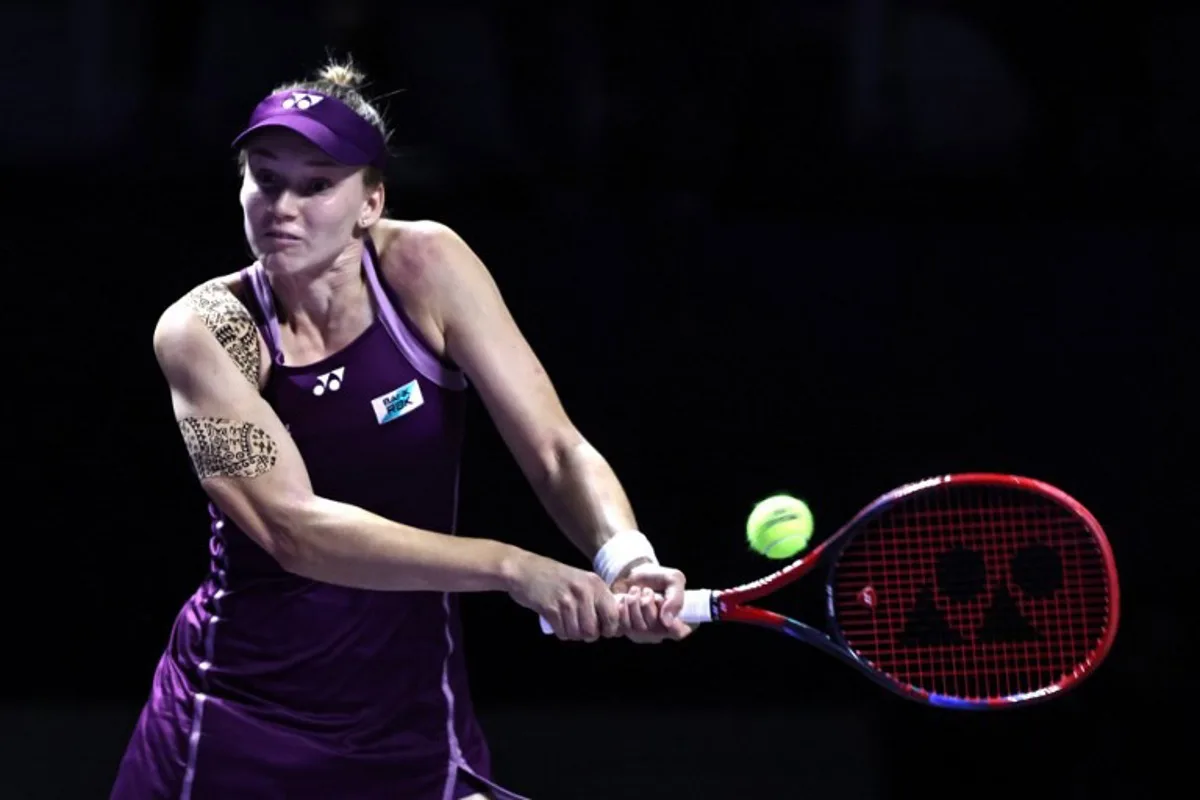 Kazakhstan's Elena Rybakina returns the ball to Russia's Ekaterina Alexandrova during their WTA Finals tennis tournament in Riyadh on November 5, 2025. Fayez NURELDINE / AFP