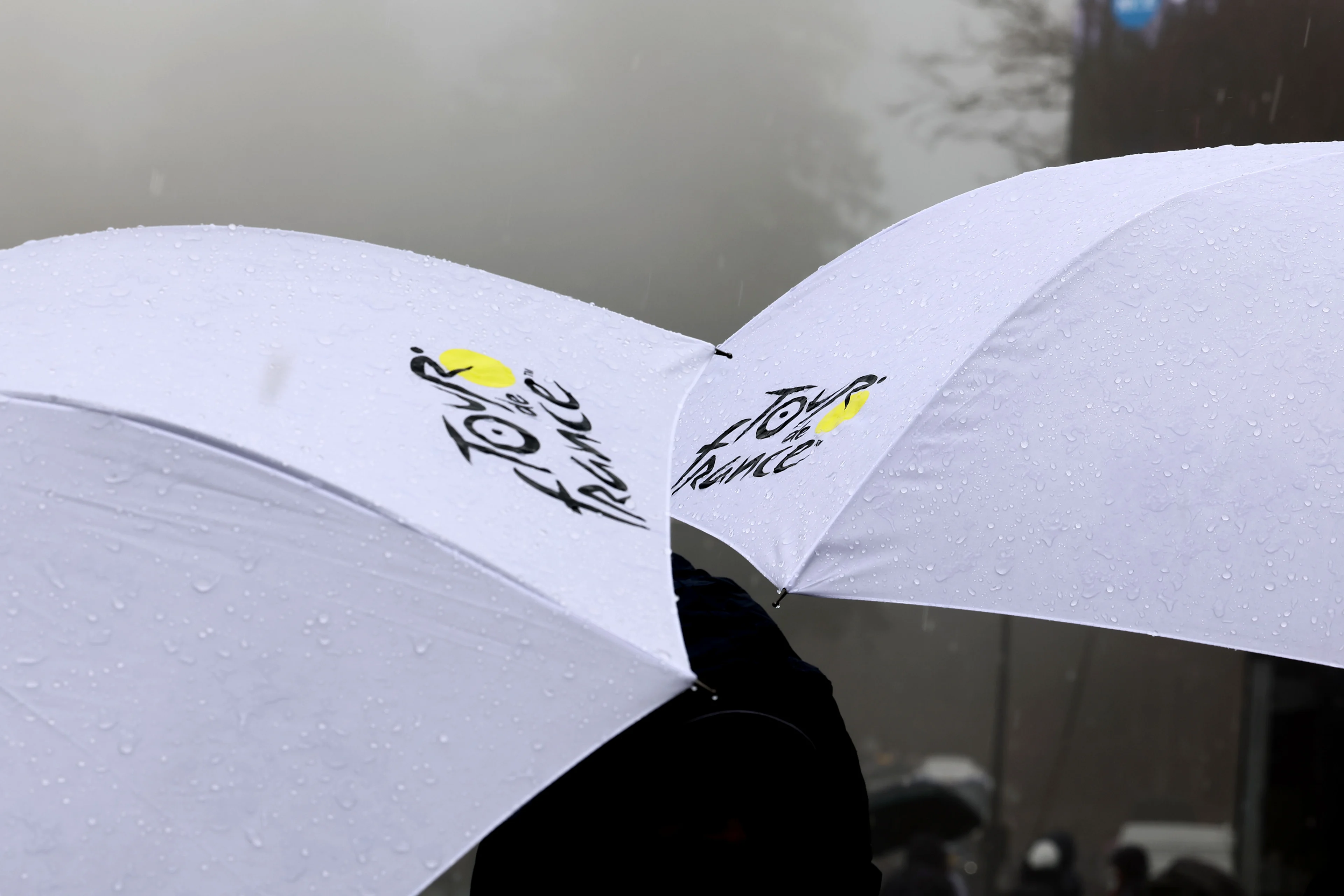 Fans with umbrellas pictured at stage four of the 83th edition of the Paris-Nice cycling race, 163,4km from Vichy to La Loge des Gardes, France, Wednesday 12 March 2025. BELGA PHOTO DAVID PINTENS