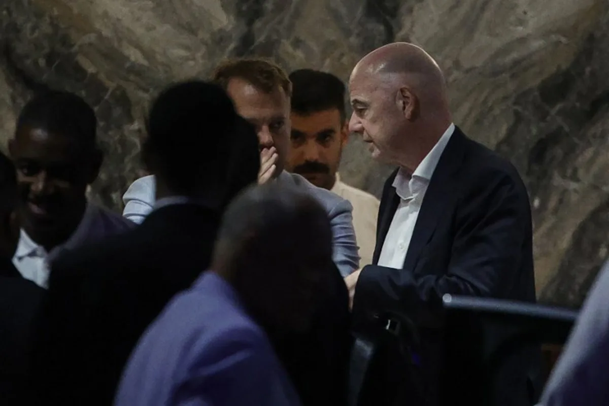 FIFA President Gianni Infantino (R) leaves Al-Madina Stadium in Rabat following the 2026 Women's Africa Cup of Nations match between Malawi and Zambia on August 5, 2026. Infantino, under fire for a now shelved plan to open the World Cup to private investment, earlier held emergency talks in Morocco with directors of the world football governing body. FIFA then issued an apology while reaffirming its "full support" for Infantino. In a statement, the leadership acknowledged "that errors were also made after the proposal was leaked to media". Abdelmajid BZIOUAT / AFP