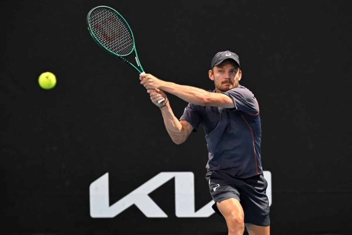 Belgium's David Goffin hits a shot against France's Benjamin Bonzi during their men's singles match on day two of the Australian Open tennis tournament in Melbourne on January 13, 2025.  Paul Crock / AFP