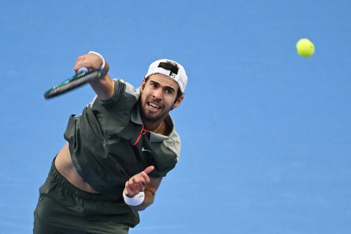 Russia's Karen Khachanov serves to Spain's Carlos Alcaraz during their men's singles quarter-final match at the China Open tennis tournament in Beijing on September 30, 2024.  GREG BAKER / AFP