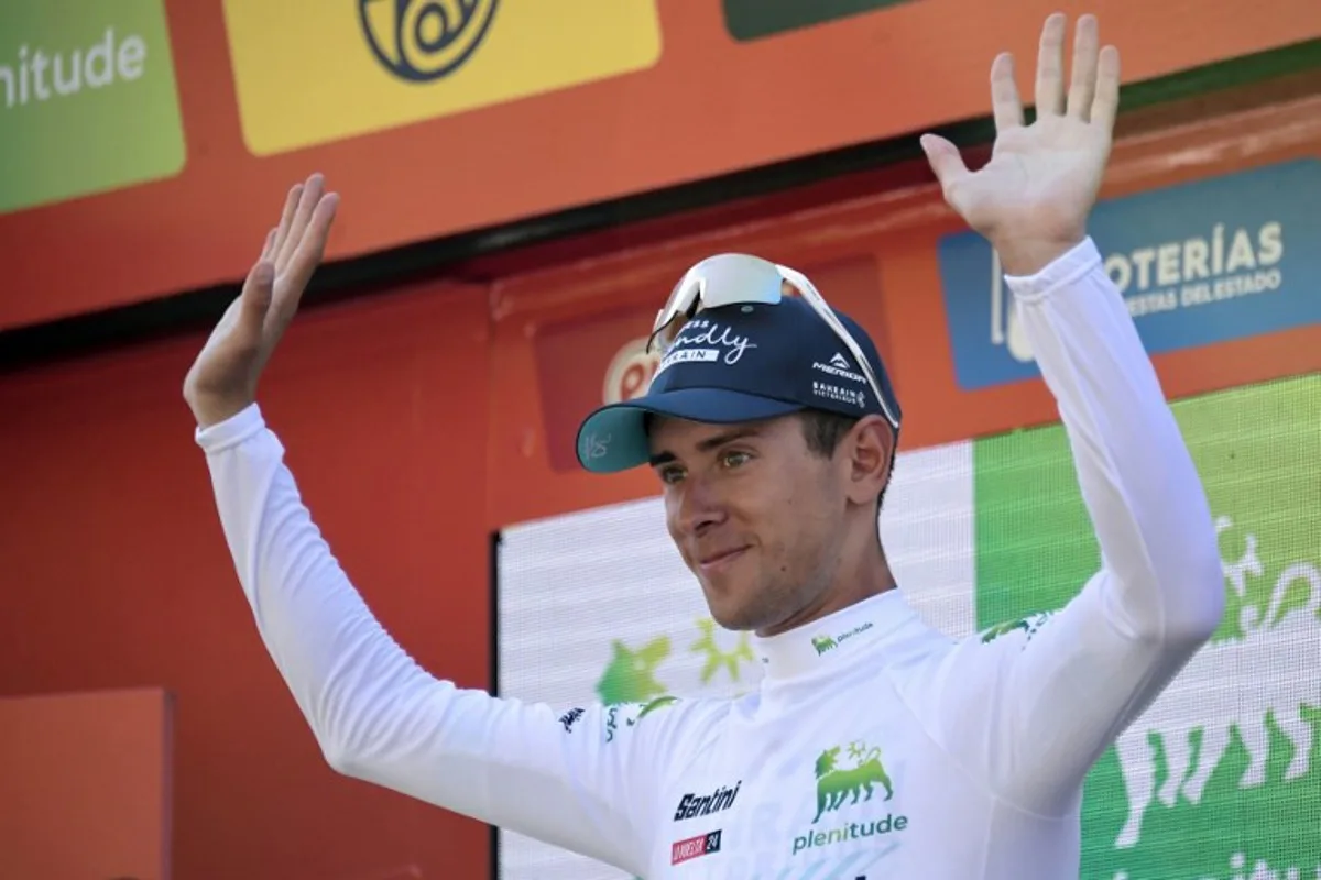 The youth ranking leader, Team Bahrain's Antonio Tiberi, celebrates on the podium wearing the white jersey after the stage 7 of La Vuelta a Espana cycling tour, a 180.5 km race between Archidona and Cordoba, on August 23, 2024.   Wout van Aert claimed his second victory at the Vuelta a Espana by taking stage seven today in a thrilling sprint finale. CRISTINA QUICLER / AFP