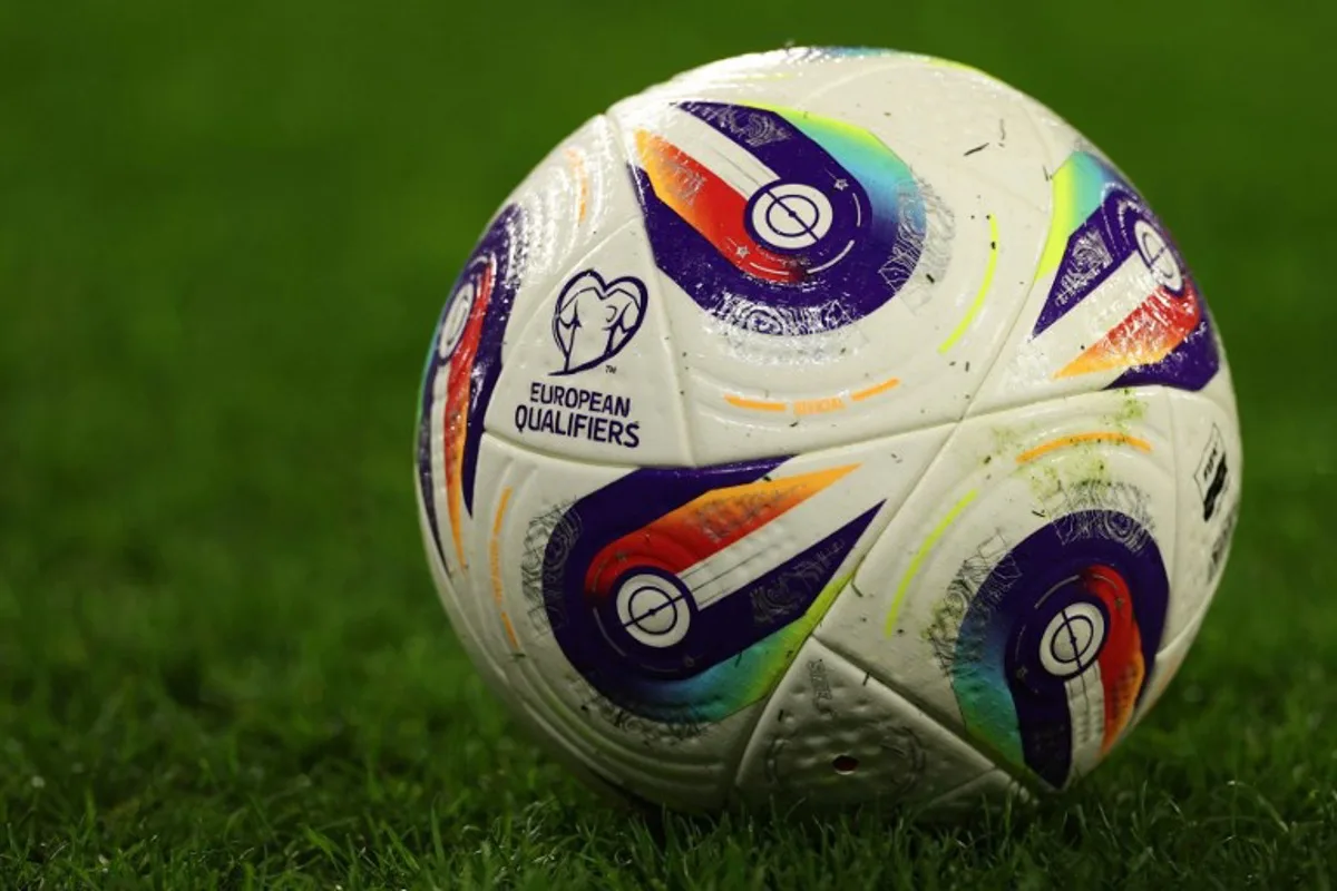 A European Qualifiers logo is pictured on a match ball ahead of the 2026 World Cup Group J qualifier football match between Wales and Kazakhstan, at Cardiff City Stadium, in Cardiff, on March 22, 2025.   Adrian Dennis / AFP