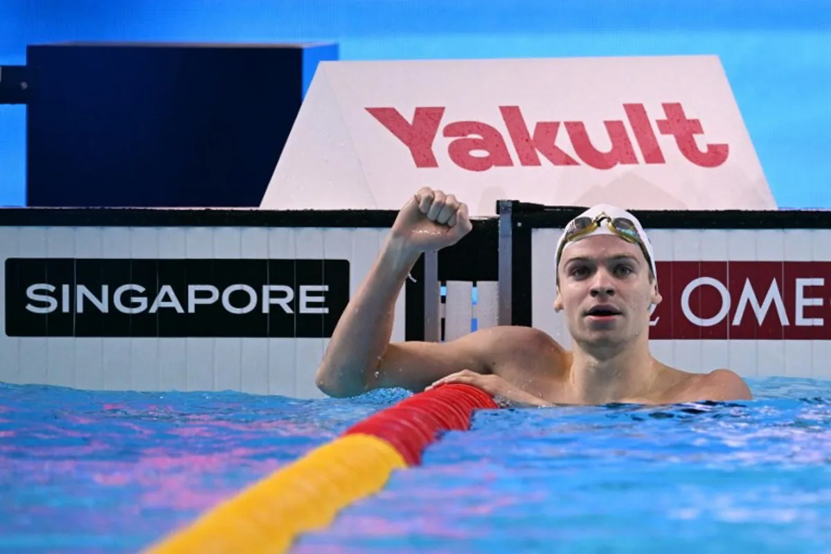 France's swimmer Leon Marchand celebrates winning the final of the men's 200m individual medley swimming event during the 2025 World Aquatics Championships in Singapore on July 31, 2025. Oli SCARFF / AFP