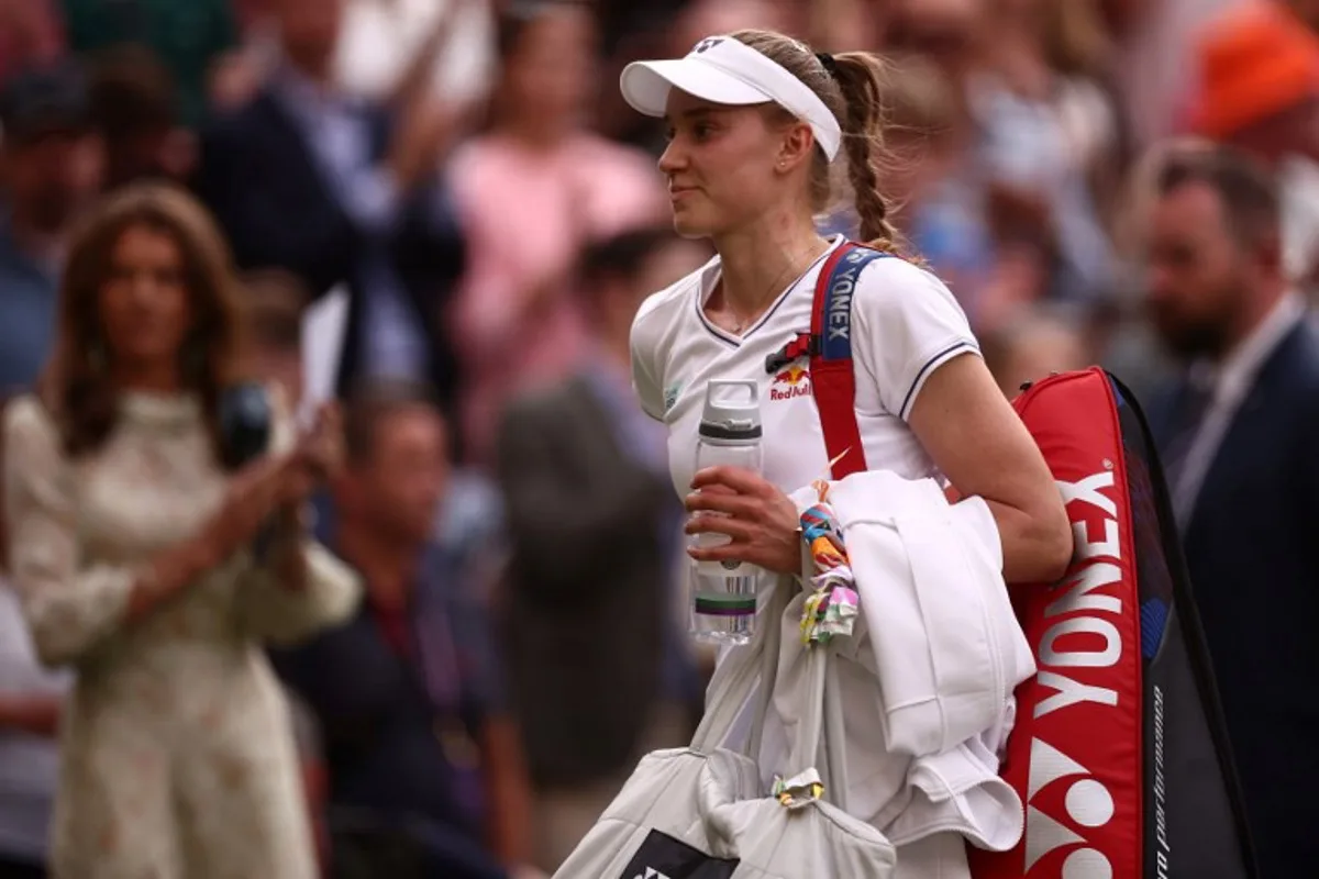 Kazakhstan's Elena Rybakina reacts as she leaves Centre Court following her defeat against Czech Republic's Barbora Krejcikova in their women's singles semi-final tennis match on the eleventh day of the 2024 Wimbledon Championships at The All England Lawn Tennis and Croquet Club in Wimbledon, southwest London, on July 11, 2024. Barbora Krejcikova won 3-6, 6-3, 6-4. HENRY NICHOLLS / AFP