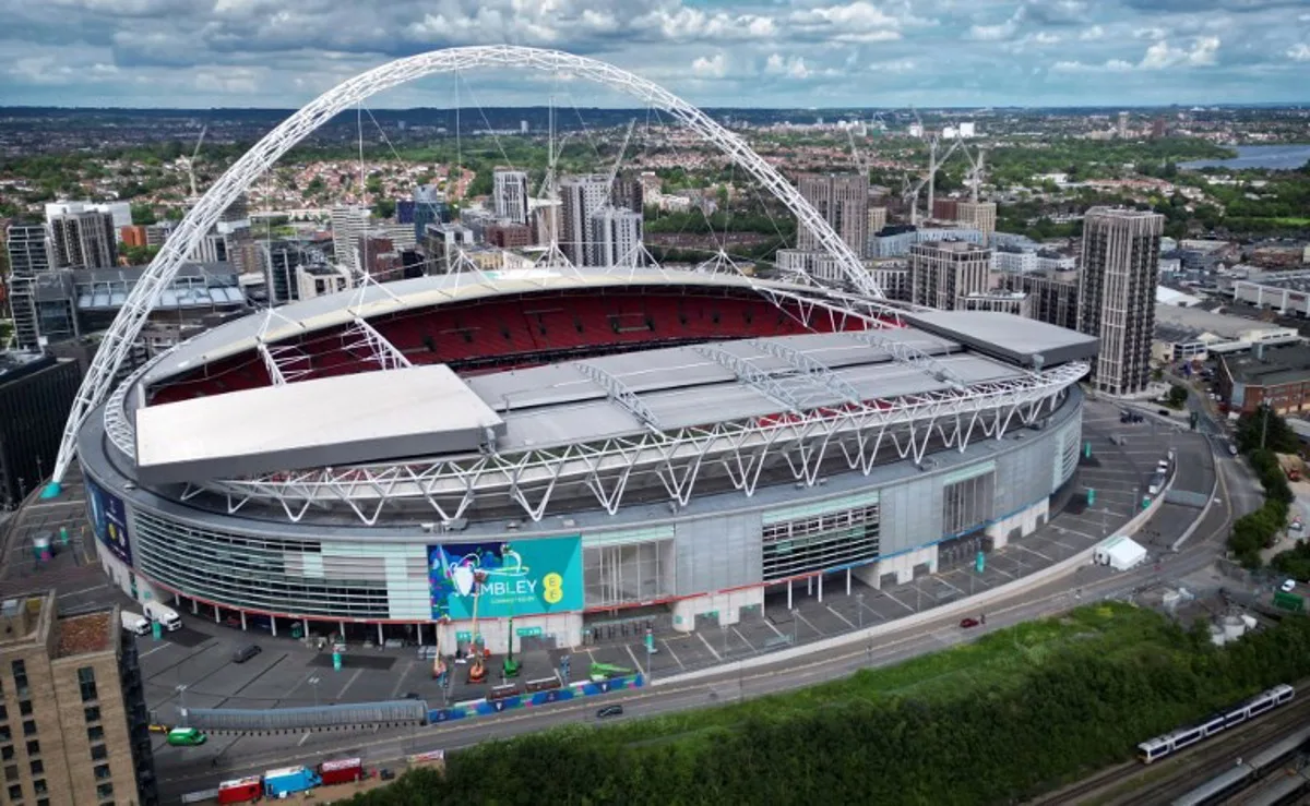 An aerial view taken on May 29, 2024, shows branding being attached to the outside of Wembley Stadium, venue for the UEFA Champions League final football match between Borussia Dortmund and Real Madrid, to be played in London on June 1, 2024. Paul ELLIS / AFP