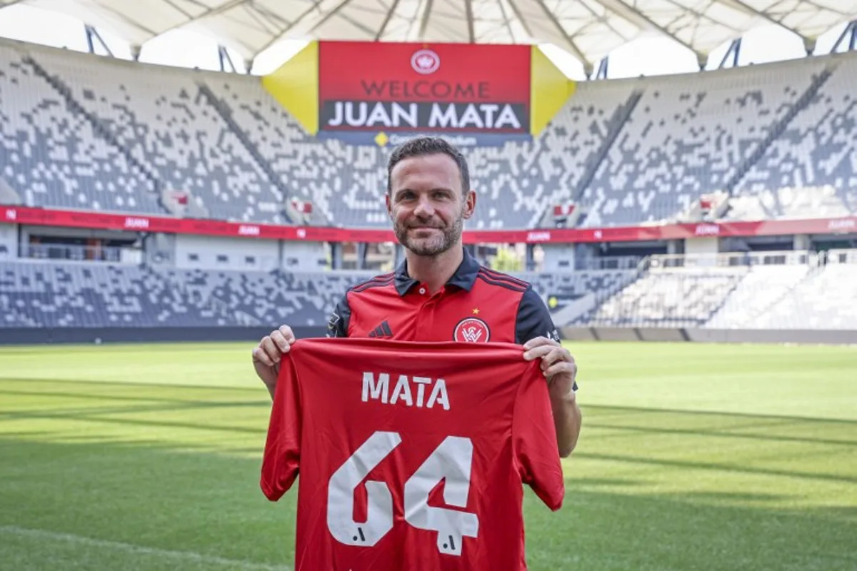 Spain's Juan Mata stands with a Western Sydney Wanderers jersey after a press conference at CommBank Stadium in Sydney on September 14, 2024. The former Spain international has signed a deal to play in Australia with the A-League football club Western Sydney Wanderers. DAVID GRAY / AFP