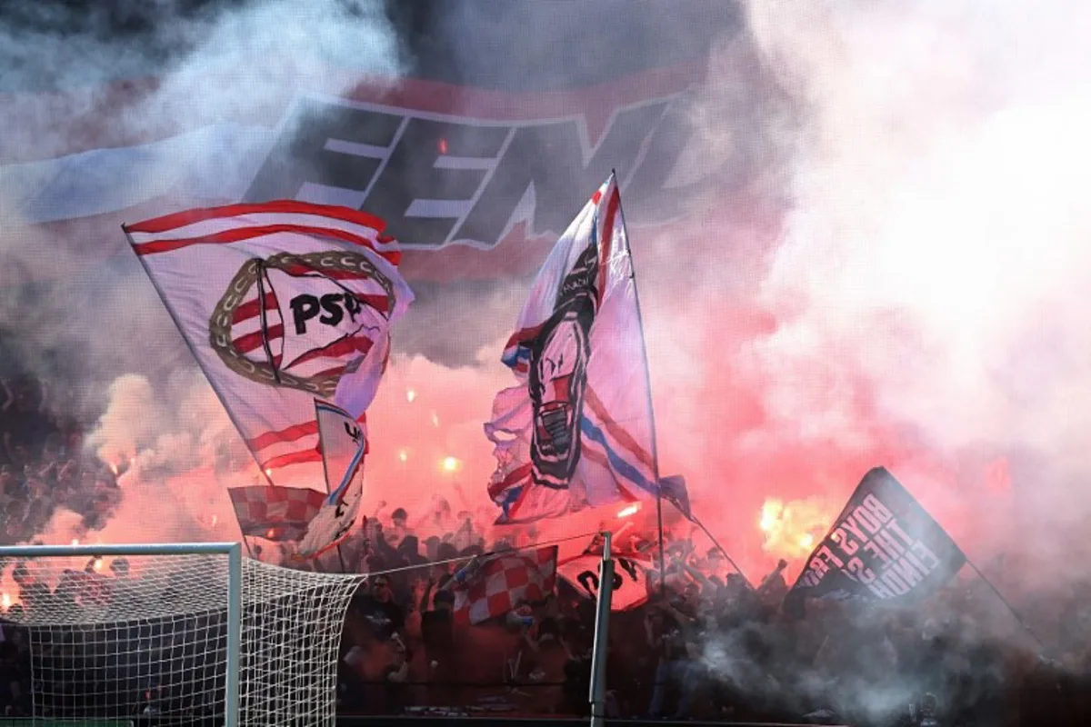 PSV supporters hold flares  during the Dutch KNVB Cup final match between PSV Eindhoven and Ajax Amsterdam at Stadion de Kuip in Rotterdam  on April 17, 2022.  Olaf Kraak / ANP / AFP