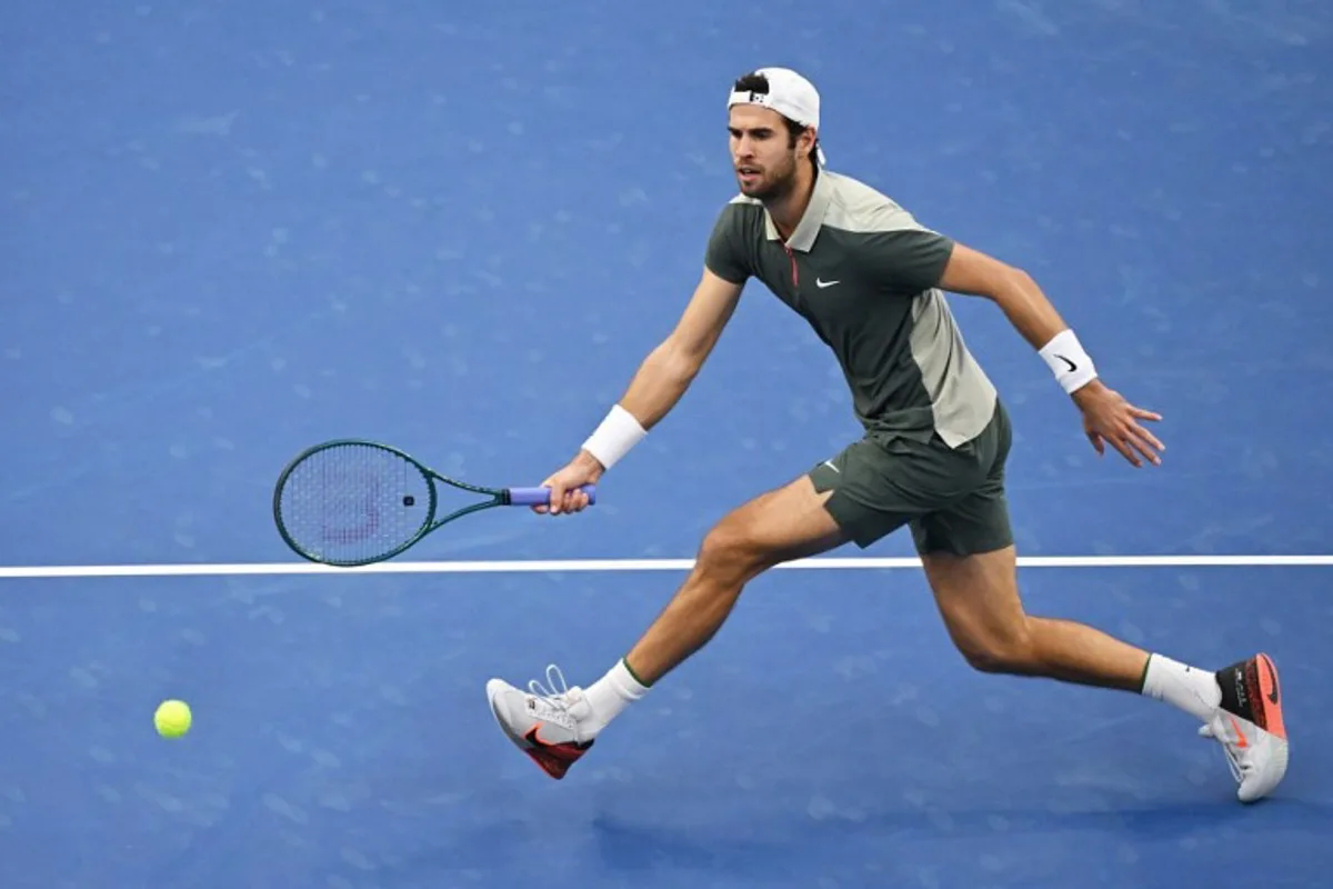 Russia's Karen Khachanov hits a return to Spain's Carlos Alcaraz during their men's singles quarter-final match at the China Open tennis tournament in Beijing on September 30, 2024.  GREG BAKER / AFP