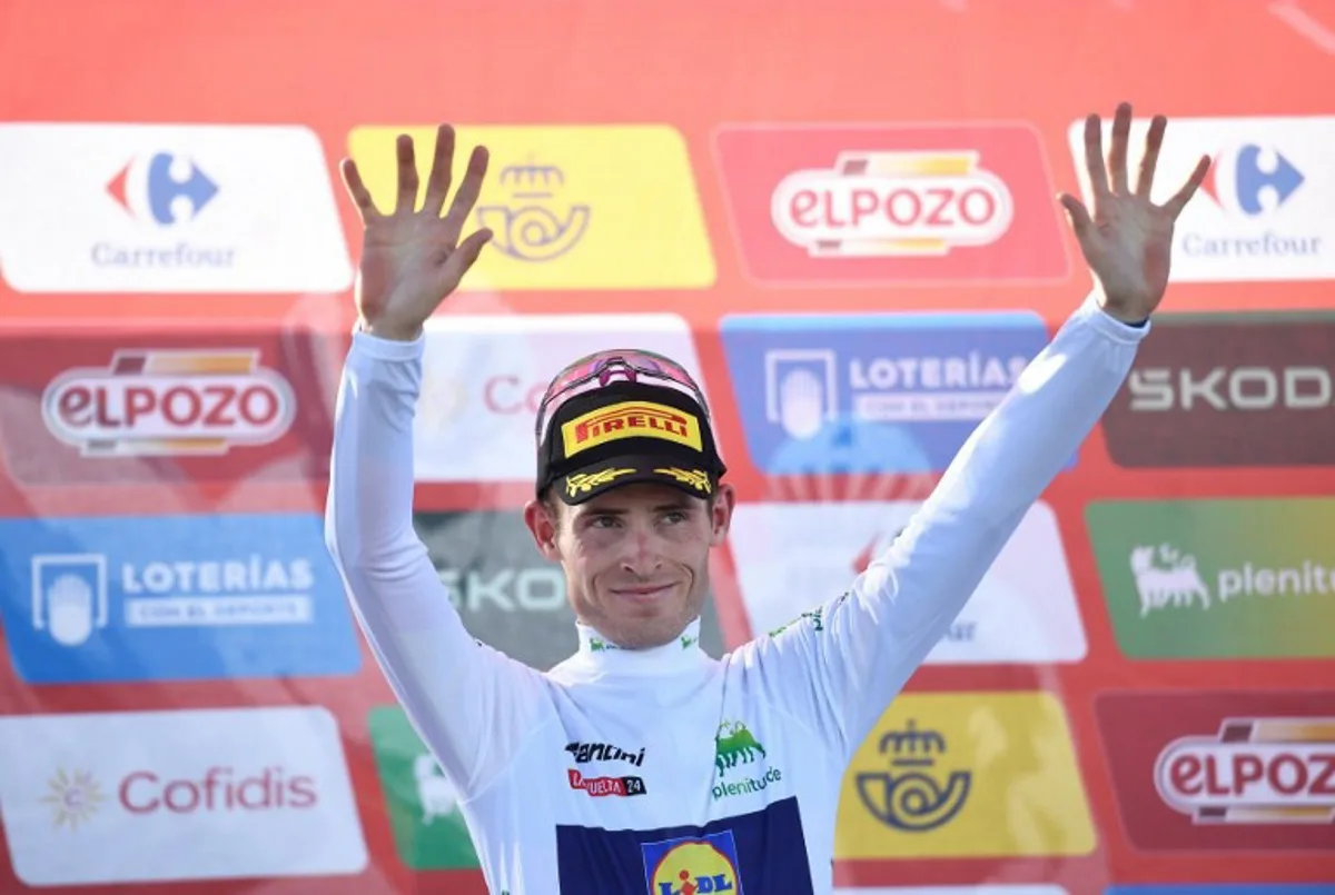 Team Lidl-Trek's Mattias Skjelmose wearing the youth ranking leader white jersey celebrates on the podium after the stage 20 of the Vuelta a Espana, a 172 km race between Villarcayo and Picon Blanco, on September 7, 2024.    ANDER GILLENEA / AFP