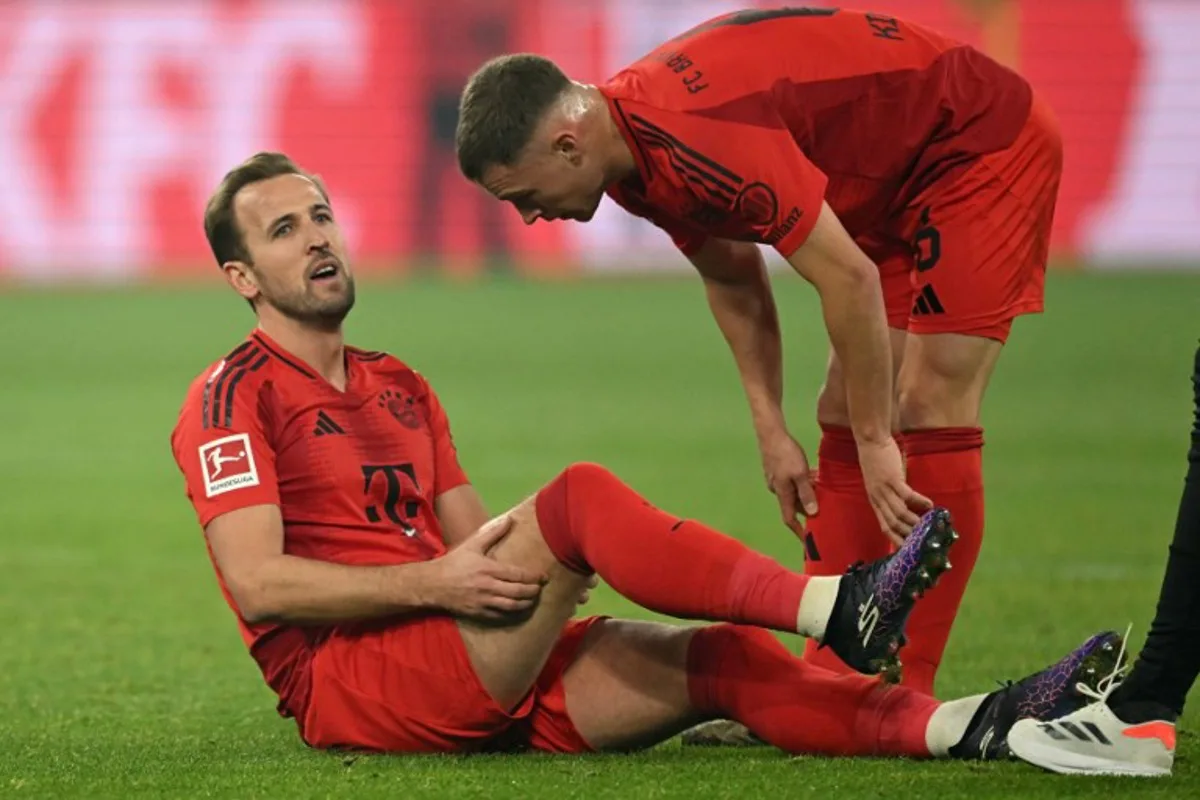 Bayern Munich's English forward #09 Harry Kane (L) speaks with Bayern Munich's German midfielder #06 Joshua Kimmich after an injury during the German first division Bundesliga football match between BVB Borussia Dortmund and FC Bayern Munich in Dortmund, western Germany on November 30, 2024.  INA FASSBENDER / AFP