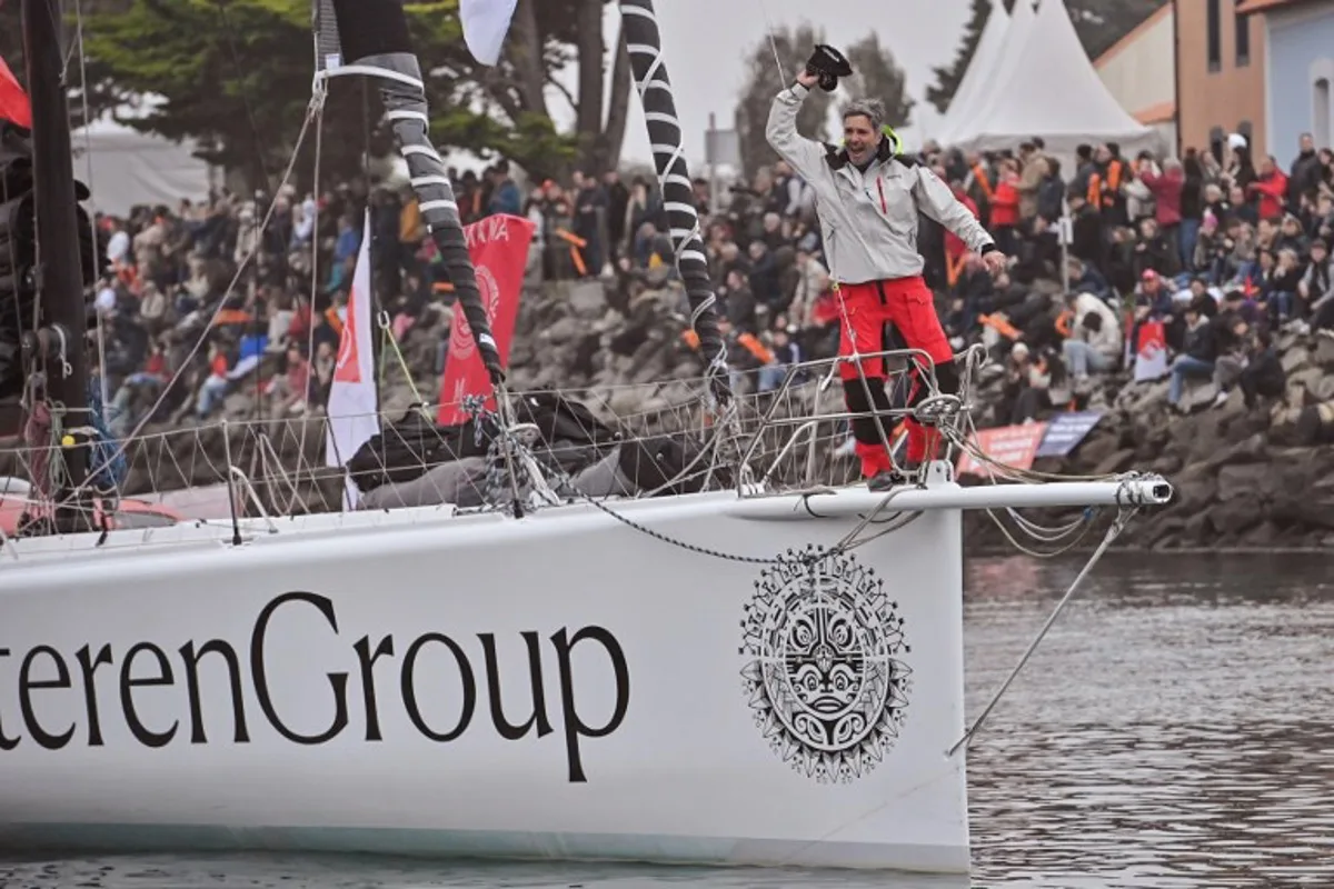 Belgian skipper Denis Van Weynbergh waves aboard his Imoca 60 "Dieteren Group" as he takes the start of the 10th edition of the Vendee Globe around the world monohull solo sailing race in Les Sables-d'Olonne, on November 10, 2024.   Sebastien Salom-Gomis / AFP