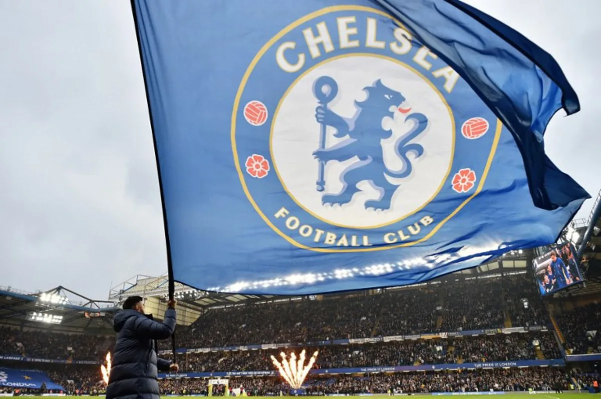 Large Chelsea flags are waved ahead of kick-off in the English Premier League football match between Chelsea and Tottenham Hotspur at Stamford Bridge in London on May 2, 2024.  Glyn KIRK / AFP