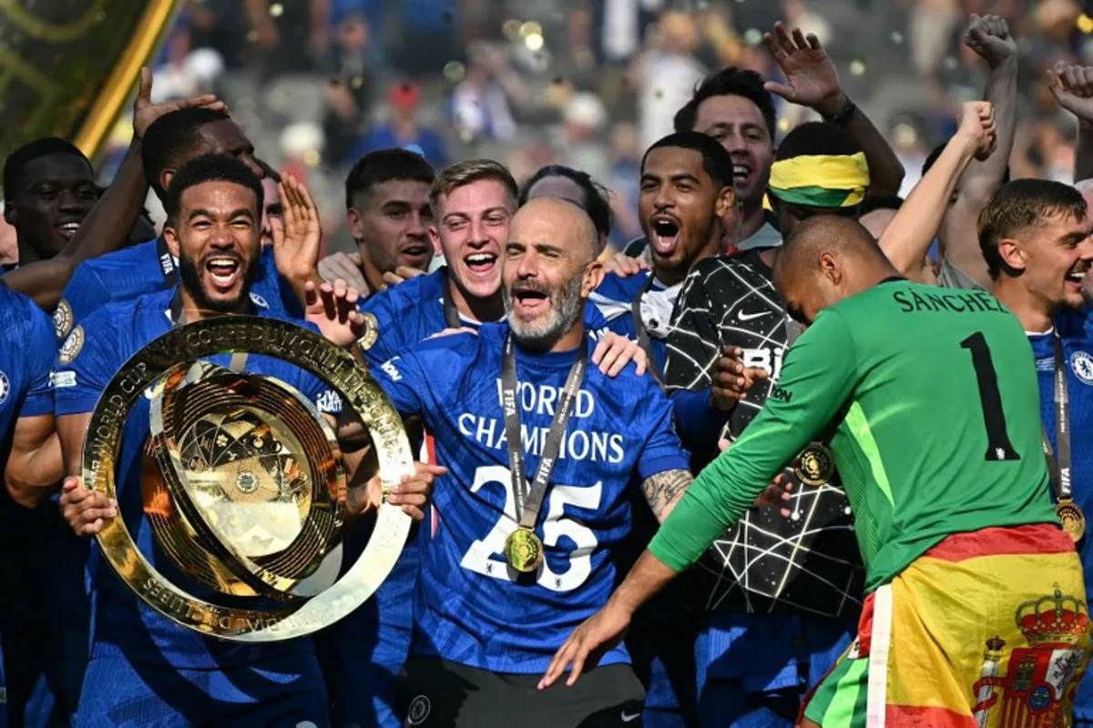 Chelsea's Italian head coach Enzo Maresca (C) celebrates with the trophy during the award ceremony for the FIFA Club World Cup 2025 Champions, following the final football match between England's Chelsea and France's Paris Saint-Germain at the MetLife Stadium in East Rutherford, New Jersey on July 13, 2025. Paul ELLIS / AFP