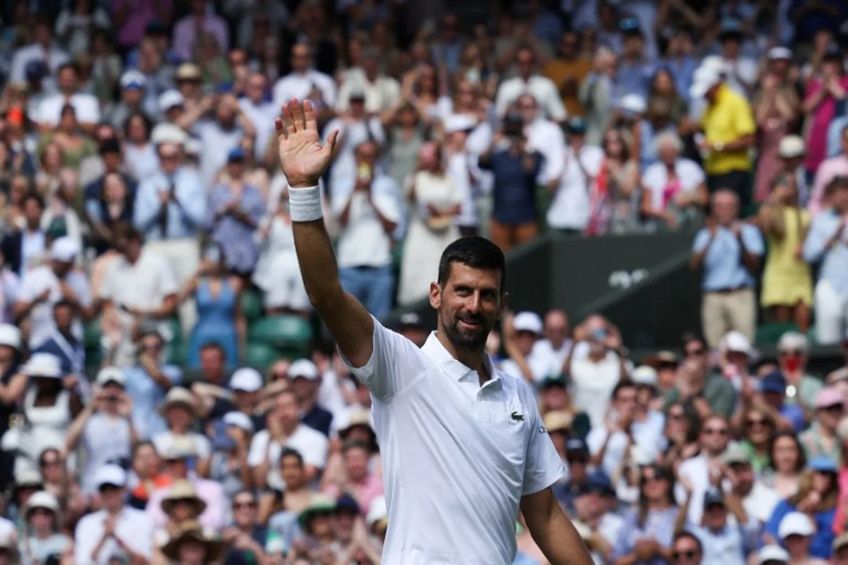 Serbia's Novak Djokovic greets the audience after winning his men's singles second round tennis match against Britain's Daniel Evans on the fourth day of the 2025 Wimbledon Championships at The All England Lawn Tennis and Croquet Club in Wimbledon, southwest London, on July 3, 2025. Adrian Dennis / AFP
