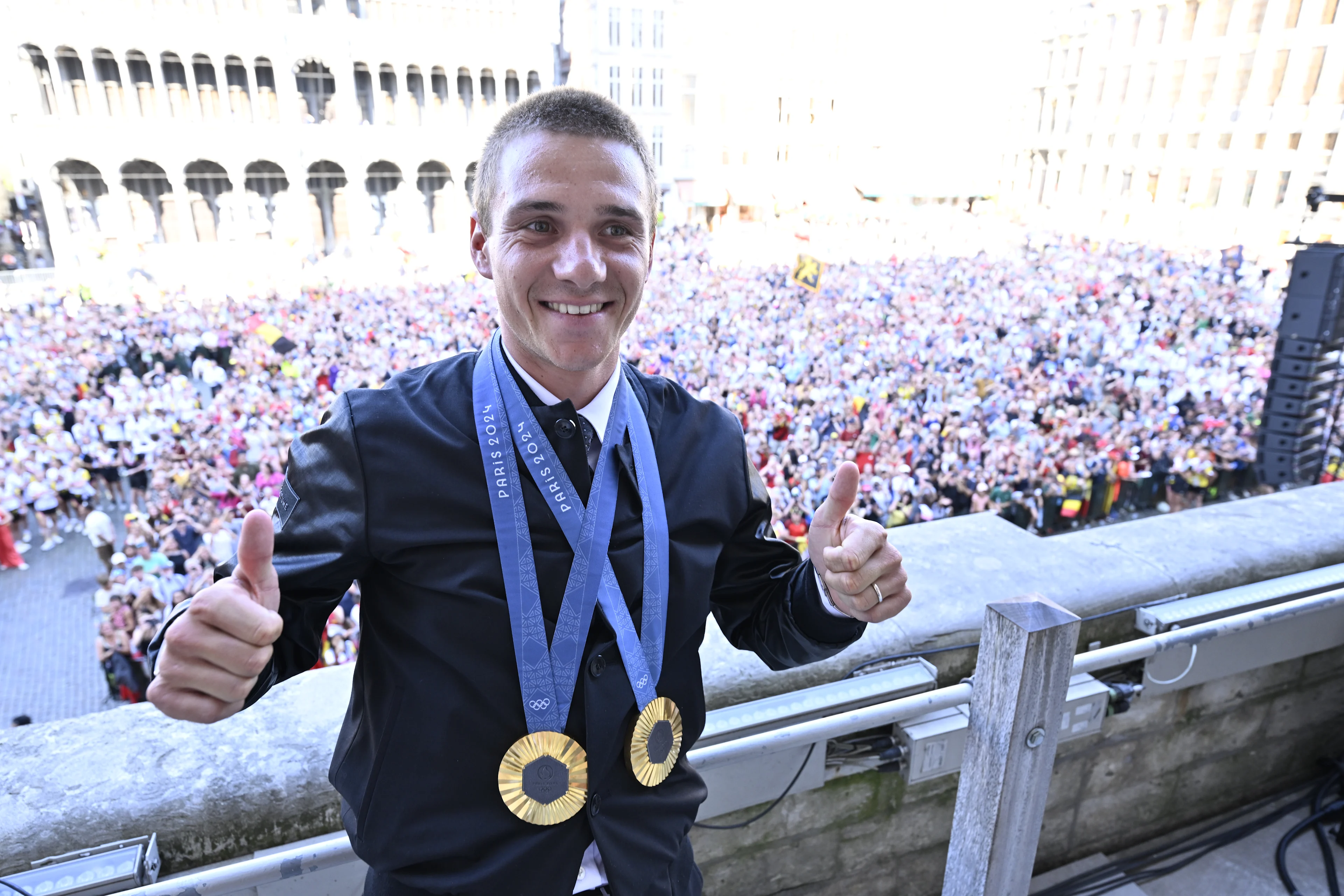 Belgian cyclist Remco Evenepoel wears with his gold medals as he poses for the photographer at celebrations after the Paris 2024 Olympic Games, at the Grand Place - Grote Markt and the Brussels City Hall, in Brussels, on Monday 12 August 2024. The Belgian delegation at the Games of the XXXIII Olympiad counted 165 athletes competing in 21 sports. BELGA PHOTO ERIC LALMAND