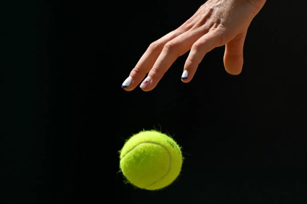 Britain's Katie Boulter bounces the ball prior to serve against Britain's Harriet Dart during their women's singles tennis match on the fourth day of the 2024 Wimbledon Championships at The All England Lawn Tennis and Croquet Club in Wimbledon, southwest London, on July 4, 2024.  Glyn KIRK / AFP