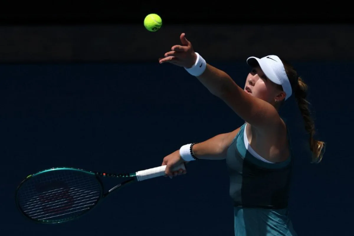 Russia's Mirra Andreeva serves against Belarus' Aryna Sabalenka during their women's singles match on day eight of the Australian Open tennis tournament in Melbourne on January 19, 2025.  Adrian DENNIS / AFP