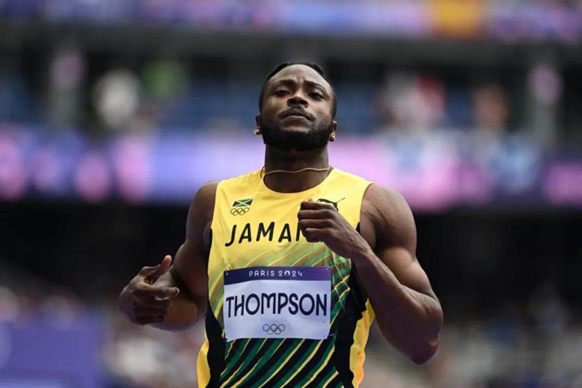 Jamaica's Kishane Thompson reacts after competing in the men's 100m heat of the athletics event at the Paris 2024 Olympic Games at Stade de France in Saint-Denis, north of Paris, on August 3, 2024. Jewel SAMAD / AFP