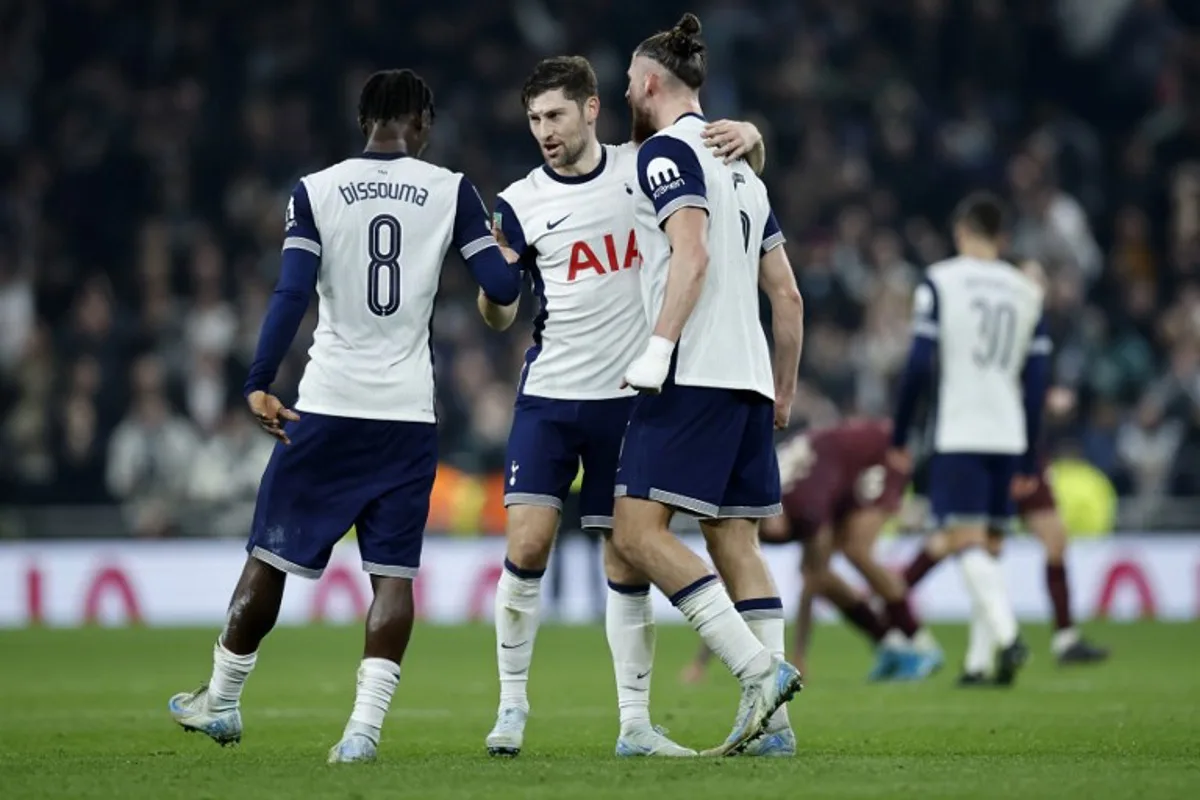 Tottenham Hotspur's Welsh defender #33 Ben Davies (C) celebrates with Tottenham Hotspur's Malian midfielder #08 Yves Bissouma and Tottenham Hotspur's Romanian defender #06 Radu Dragusin (R) following the English League Cup round of 16 football match between Tottenham Hotspur and Manchester City at the Tottenham Hotspur Stadium in London, on October 30, 2024.  BENJAMIN CREMEL / AFP