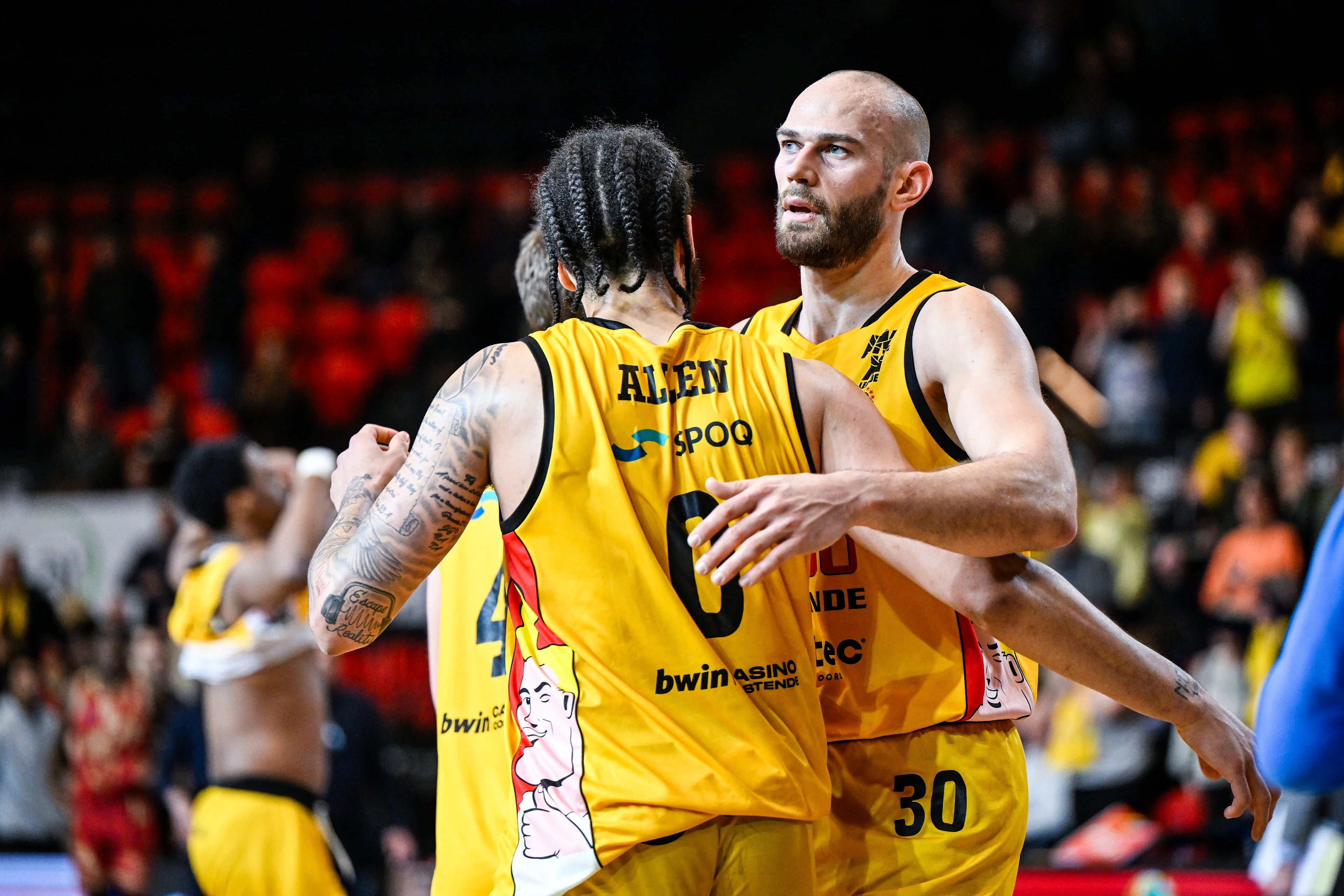 Oostende's Timmy Allen and Oostende's Pierre-Antoine Gillet celebrate after winning a basketball match between Filou Oostende and Antwerp Giants, Thursday 13 February 2025 in Oostende, the return leg of the semi-finals of the men's Belgian Basketball Cup. BELGA PHOTO TOM GOYVAERTS